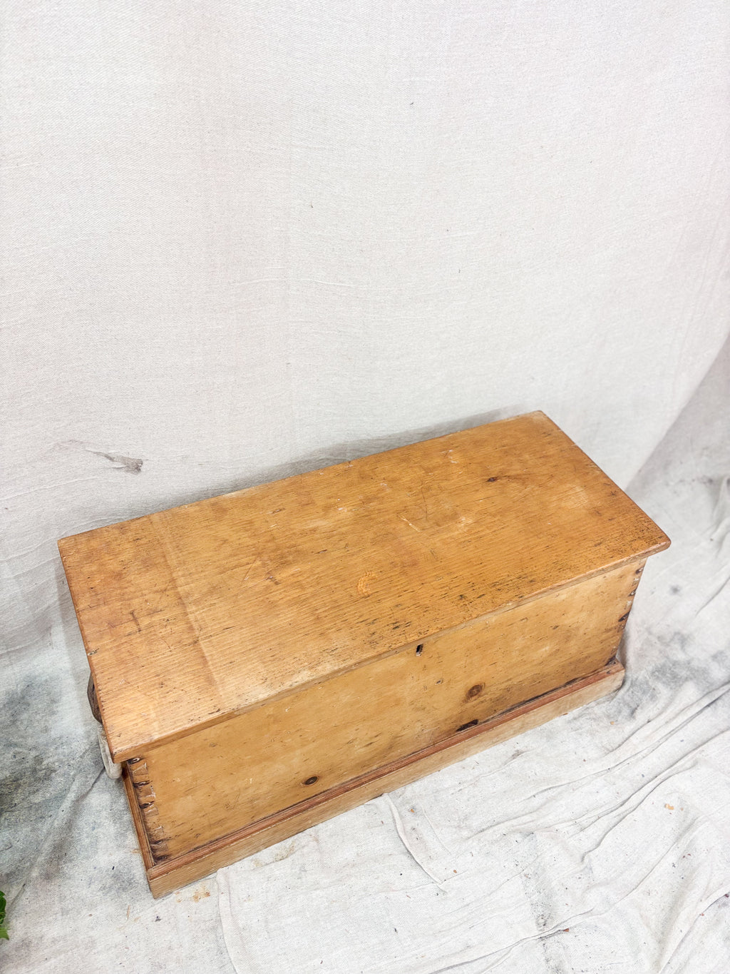Wooden box on a textured white surface
