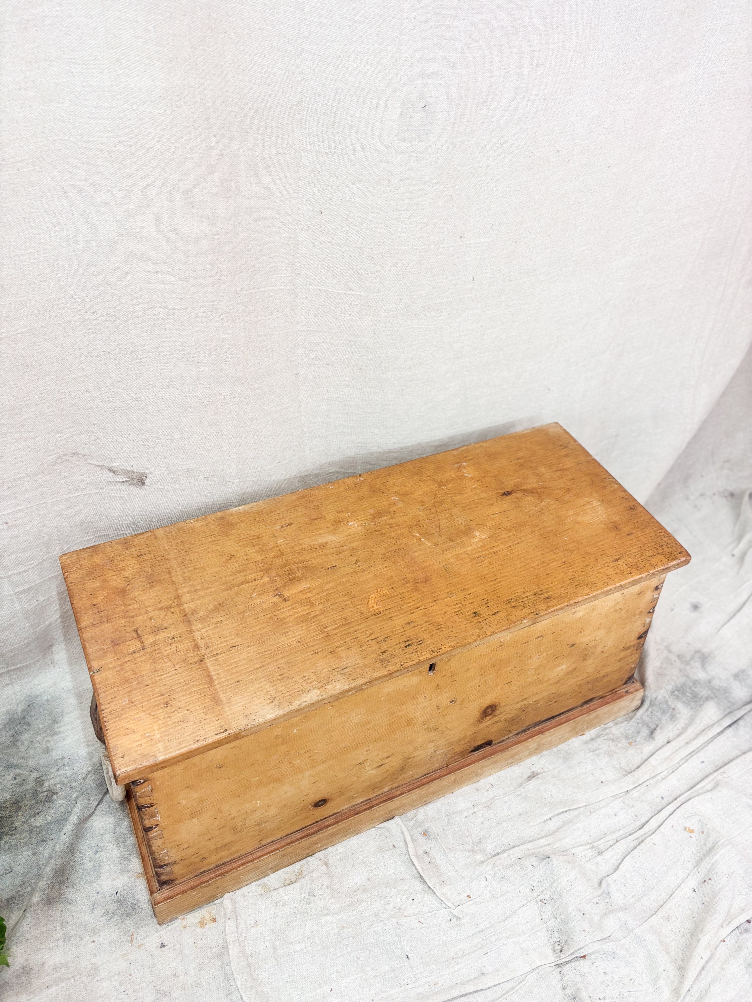 Wooden box on a textured white surface