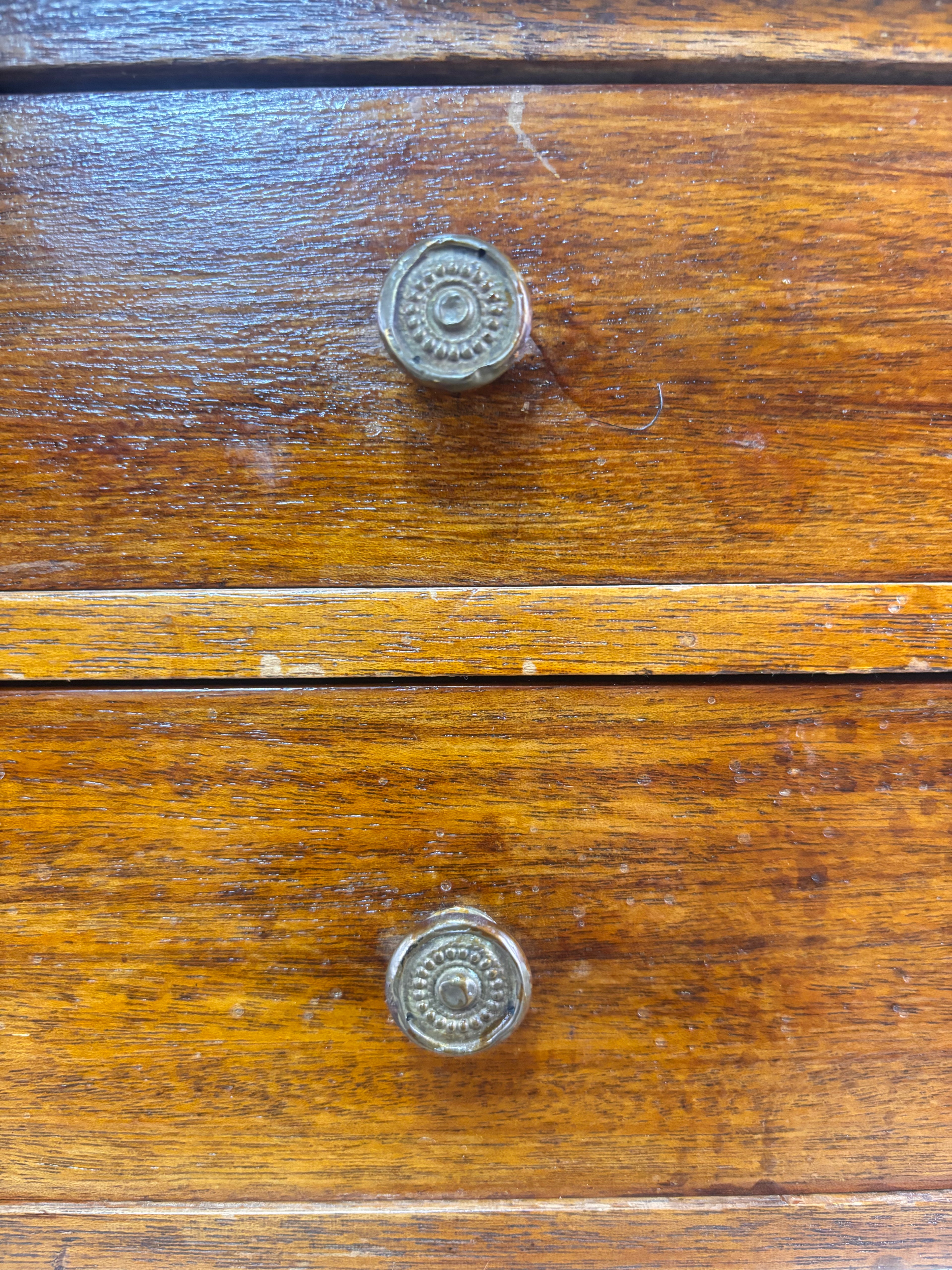Details of handles on Regency-style mahogany side table with two drawers. 