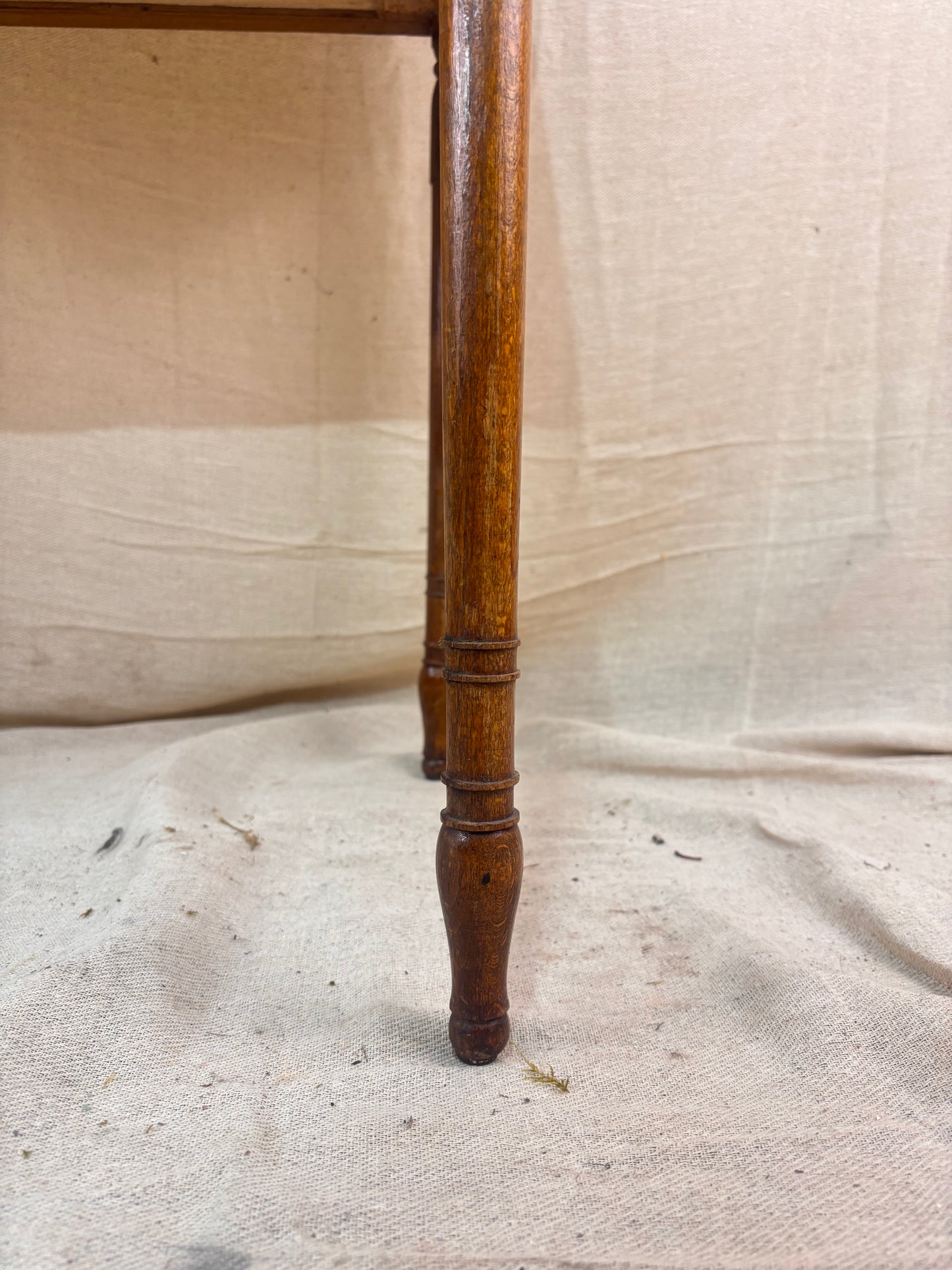 Regency-style mahogany side table with slender ring-turned legs, and a neo-classical design, shown on a neutral background.