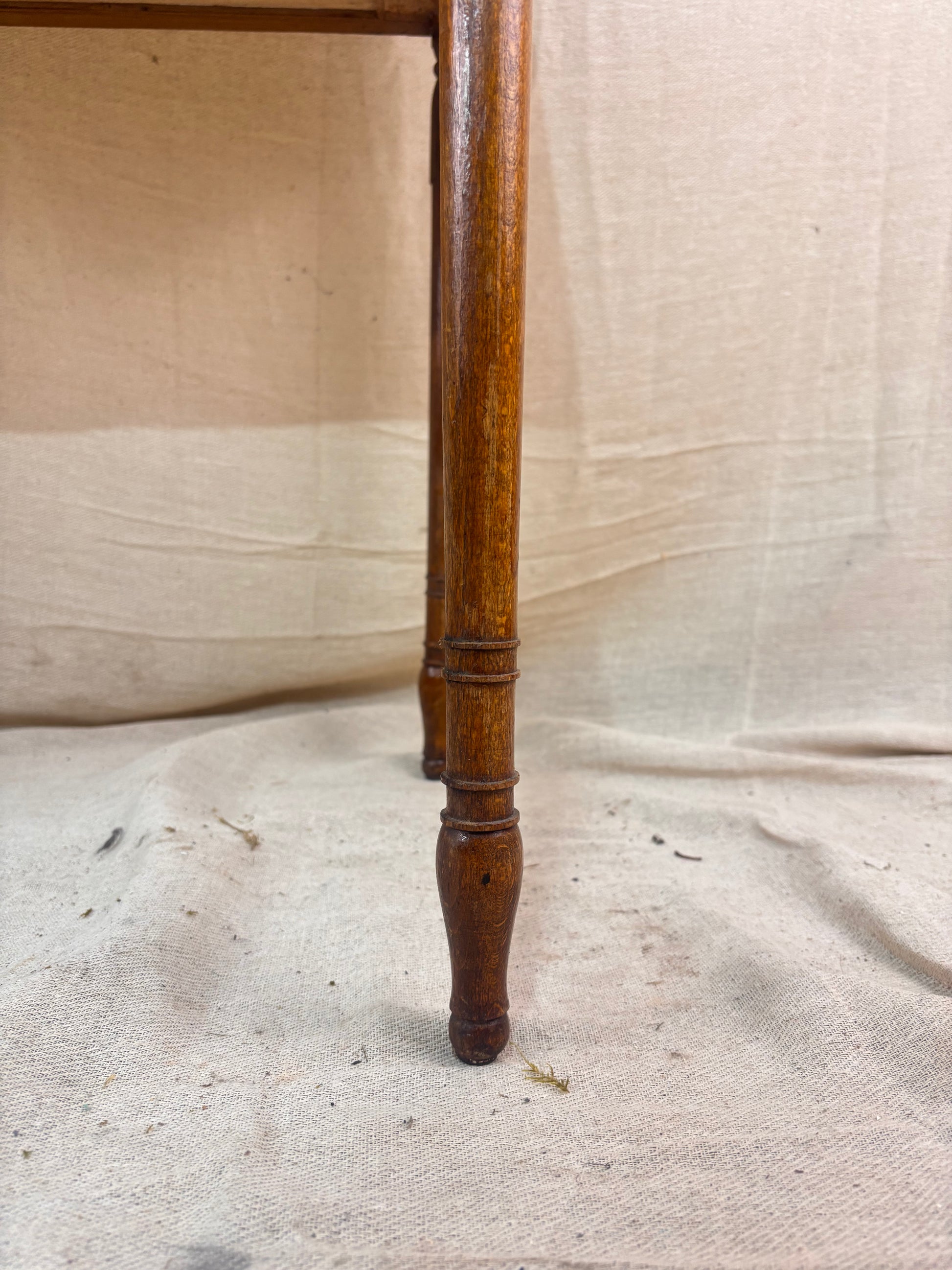 Regency-style mahogany side table with slender ring-turned legs, and a neo-classical design, shown on a neutral background.