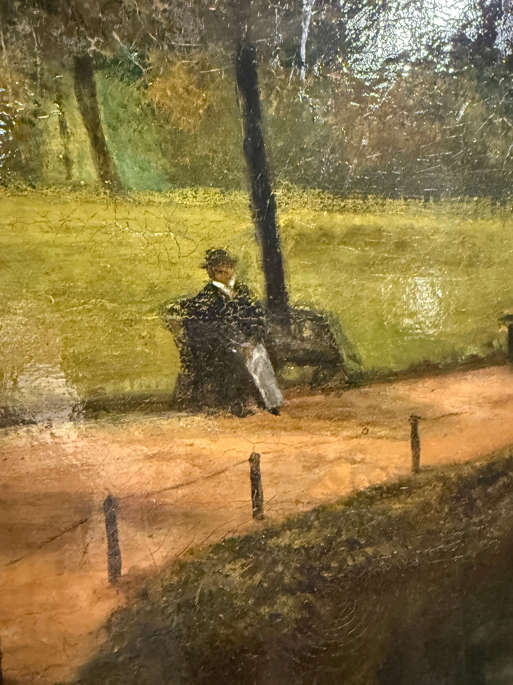 Signed H. Mann and dated 1897, this 19th-century oil painting depicts a tranquil park scene with a lone figure, set in an ornate gilt frame.