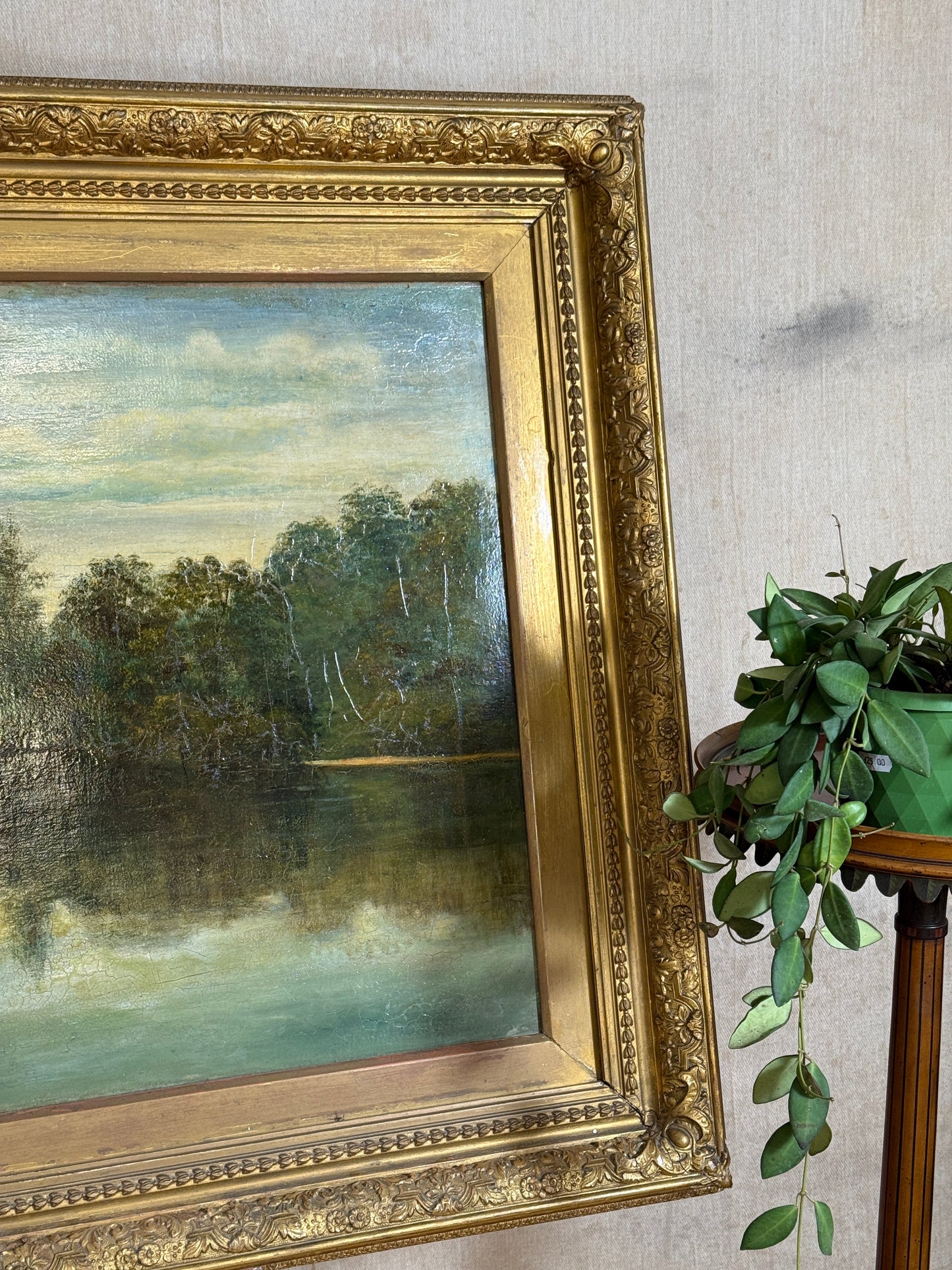 Signed H. Mann and dated 1897, this 19th-century oil painting depicts a tranquil park scene with a lone figure, set in an ornate gilt frame.