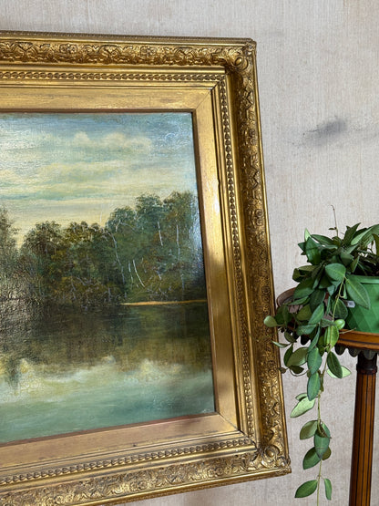Signed H. Mann and dated 1897, this 19th-century oil painting depicts a tranquil park scene with a lone figure, set in an ornate gilt frame.