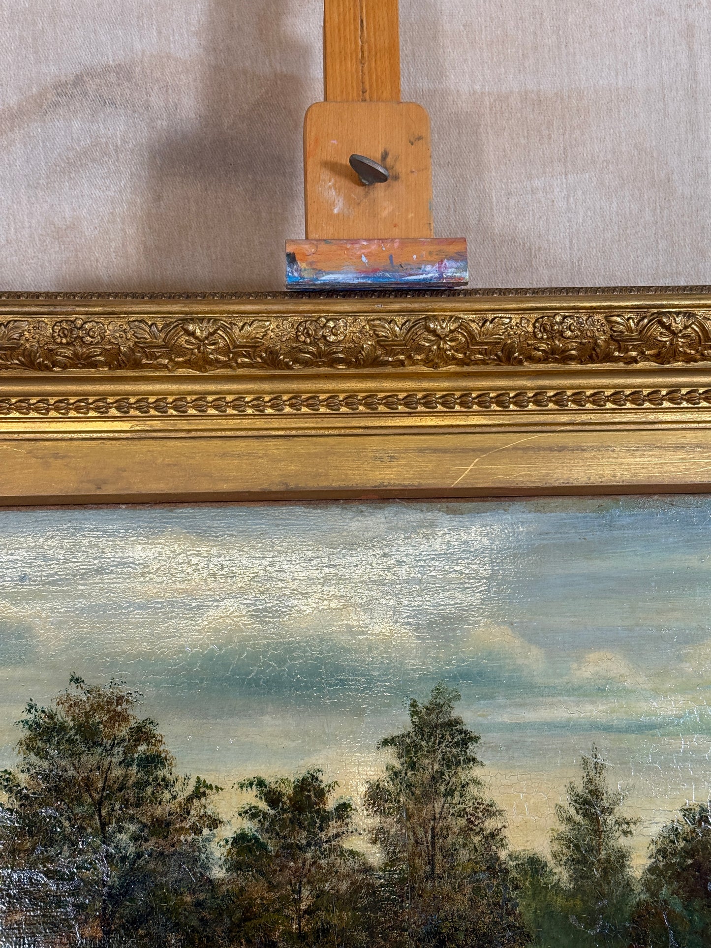 Signed H. Mann and dated 1897, this 19th-century oil painting depicts a tranquil park scene with a lone figure, set in an ornate gilt frame.
