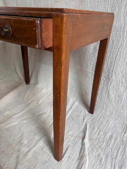 Wooden desk with a single drawer on a textured white background