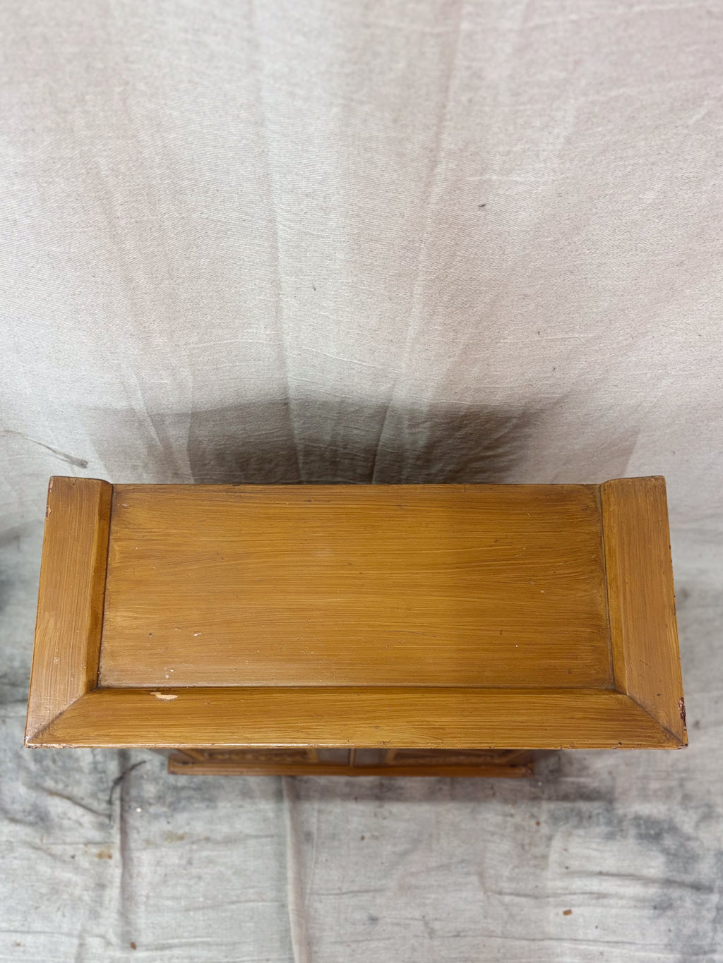 Top of a wooden cabinet. 