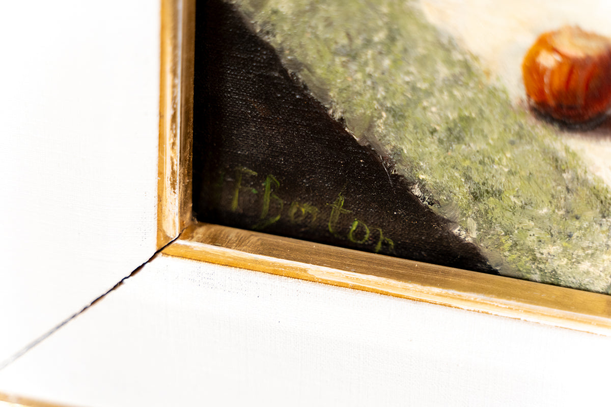 Close-up detail of a framed artwork corner, showing a gold-toned frame, textured green brushwork, a dark shadowed area with faint green script, and part of a small orange-brown object in the upper right.