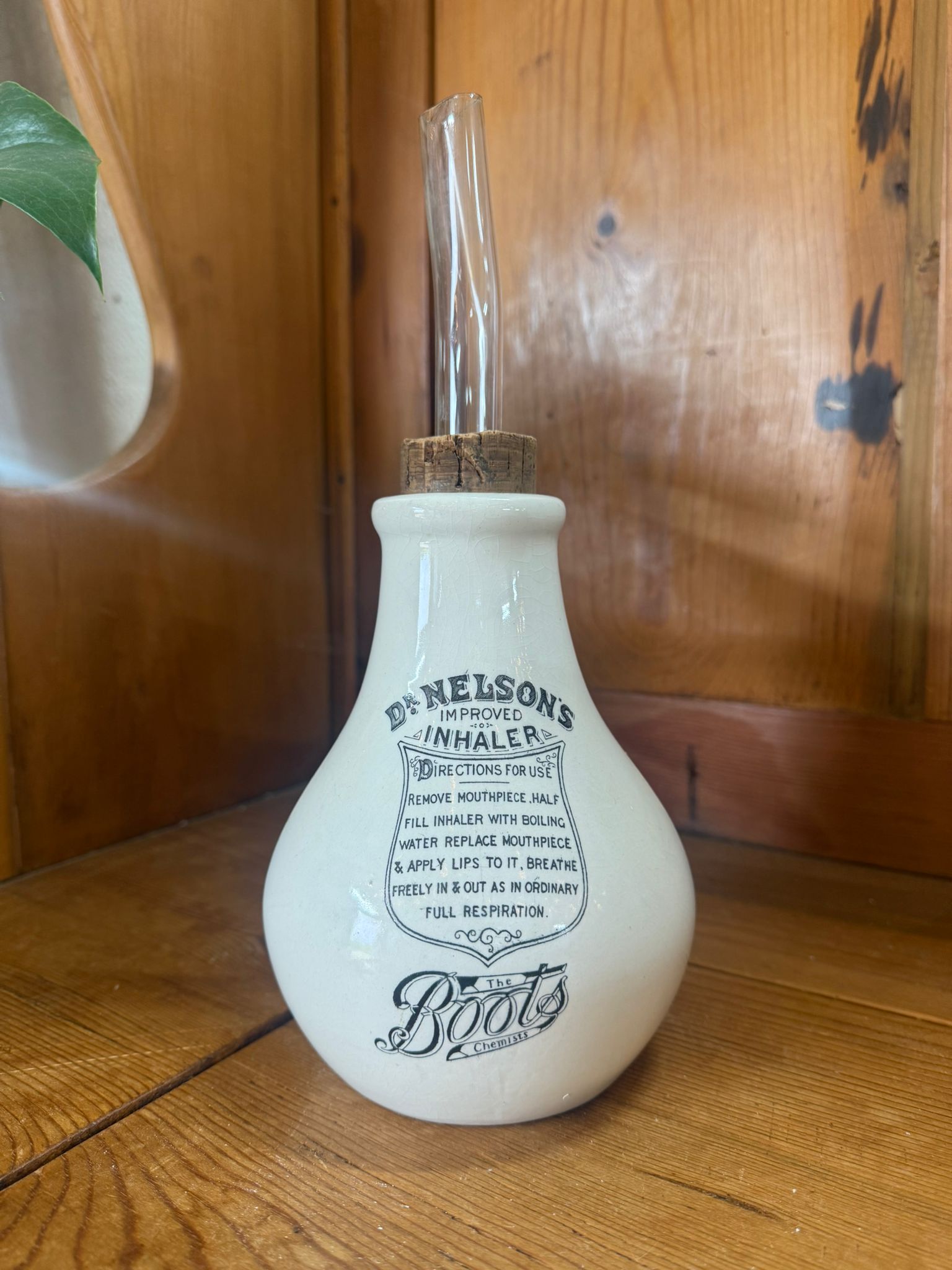 Vintage-style white bottle with label on a wooden surface
