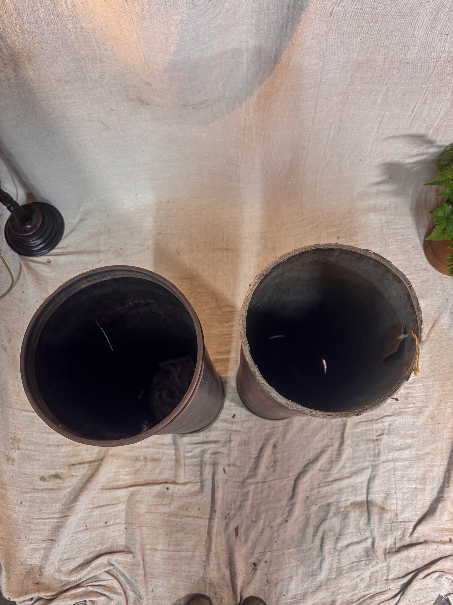 Two tubes on a textured surface with a light background