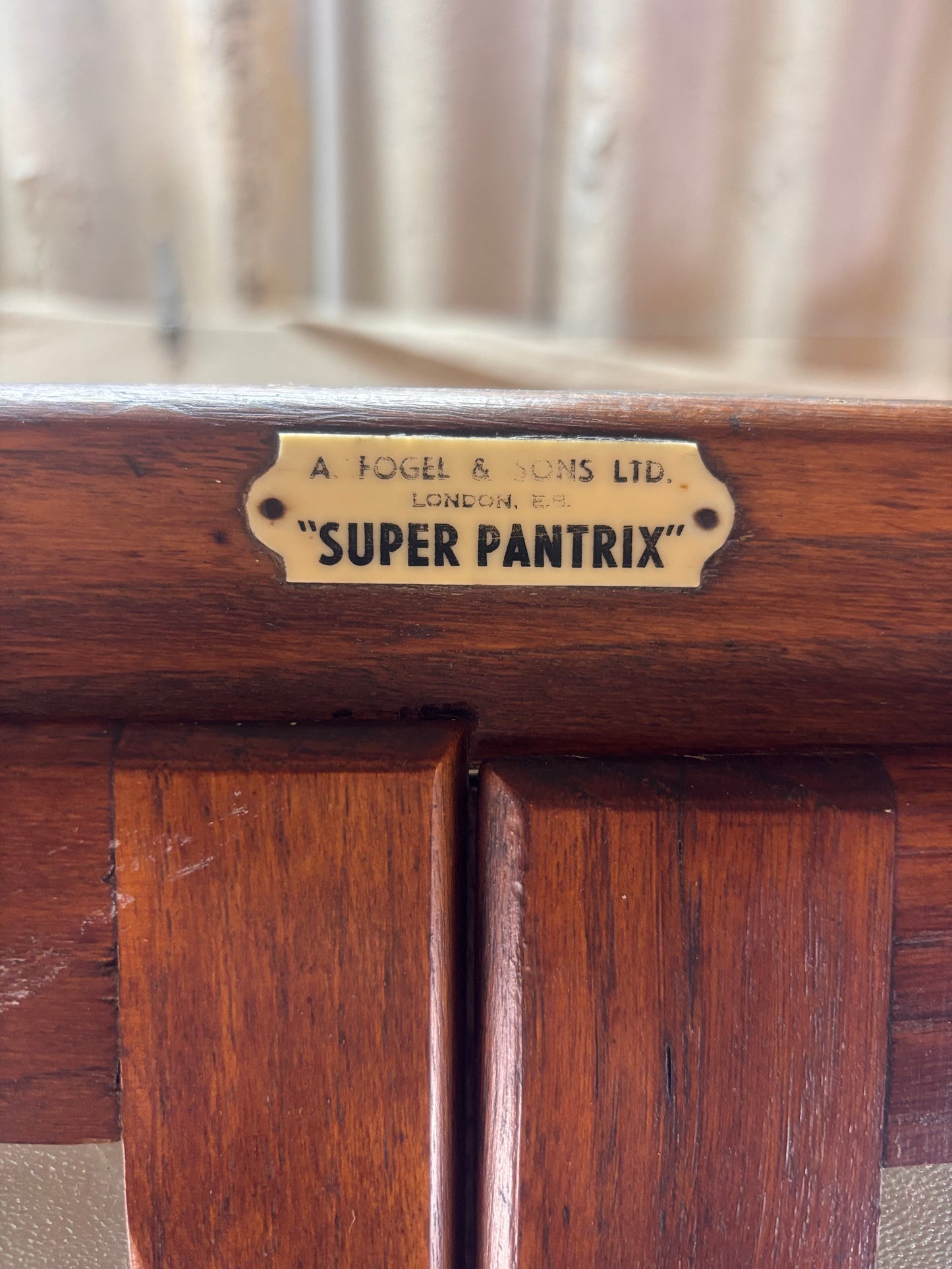 Wooden appliance with 'Super Pantrix' label on a blurred background