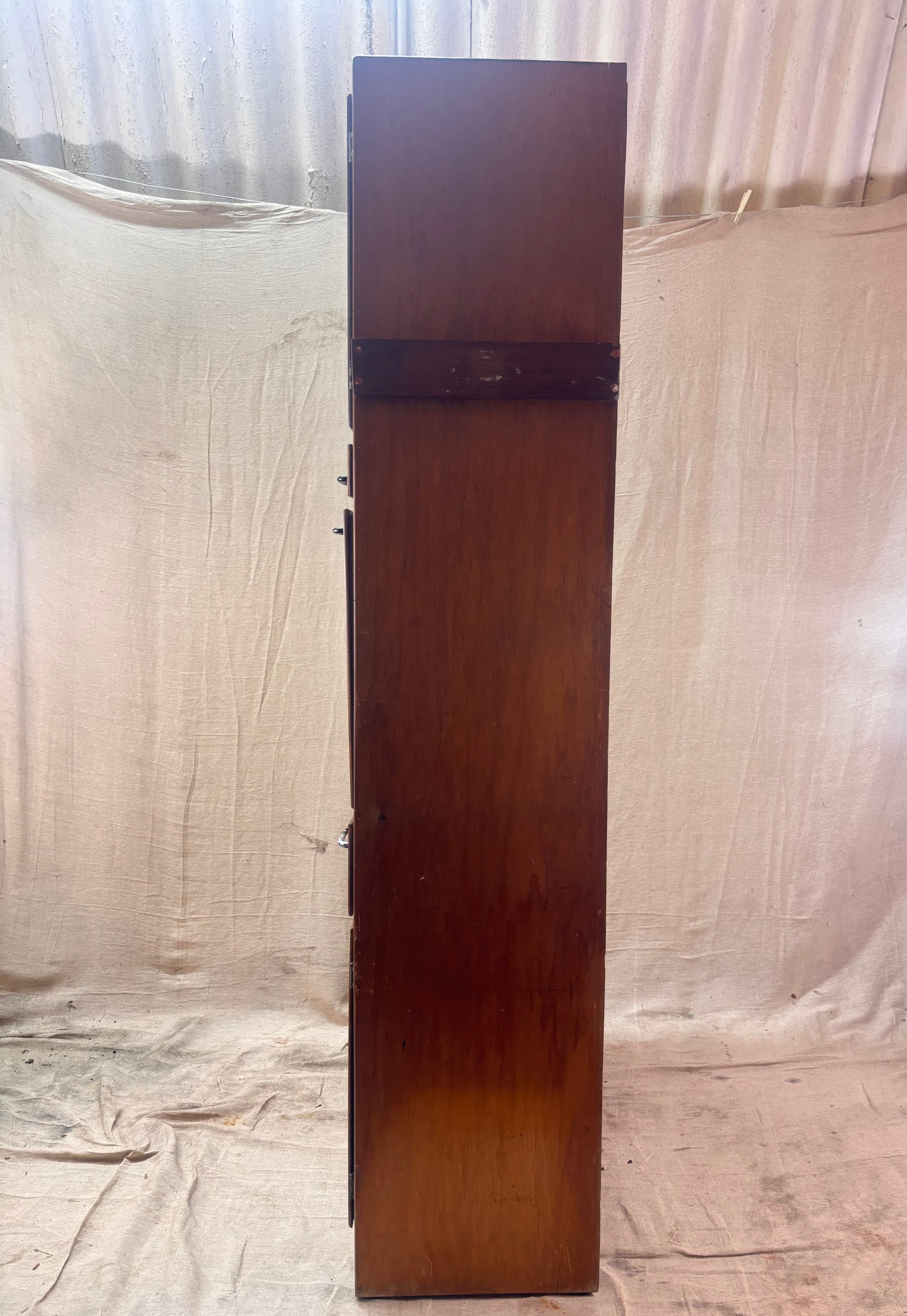Tall wooden cabinet against a plain background