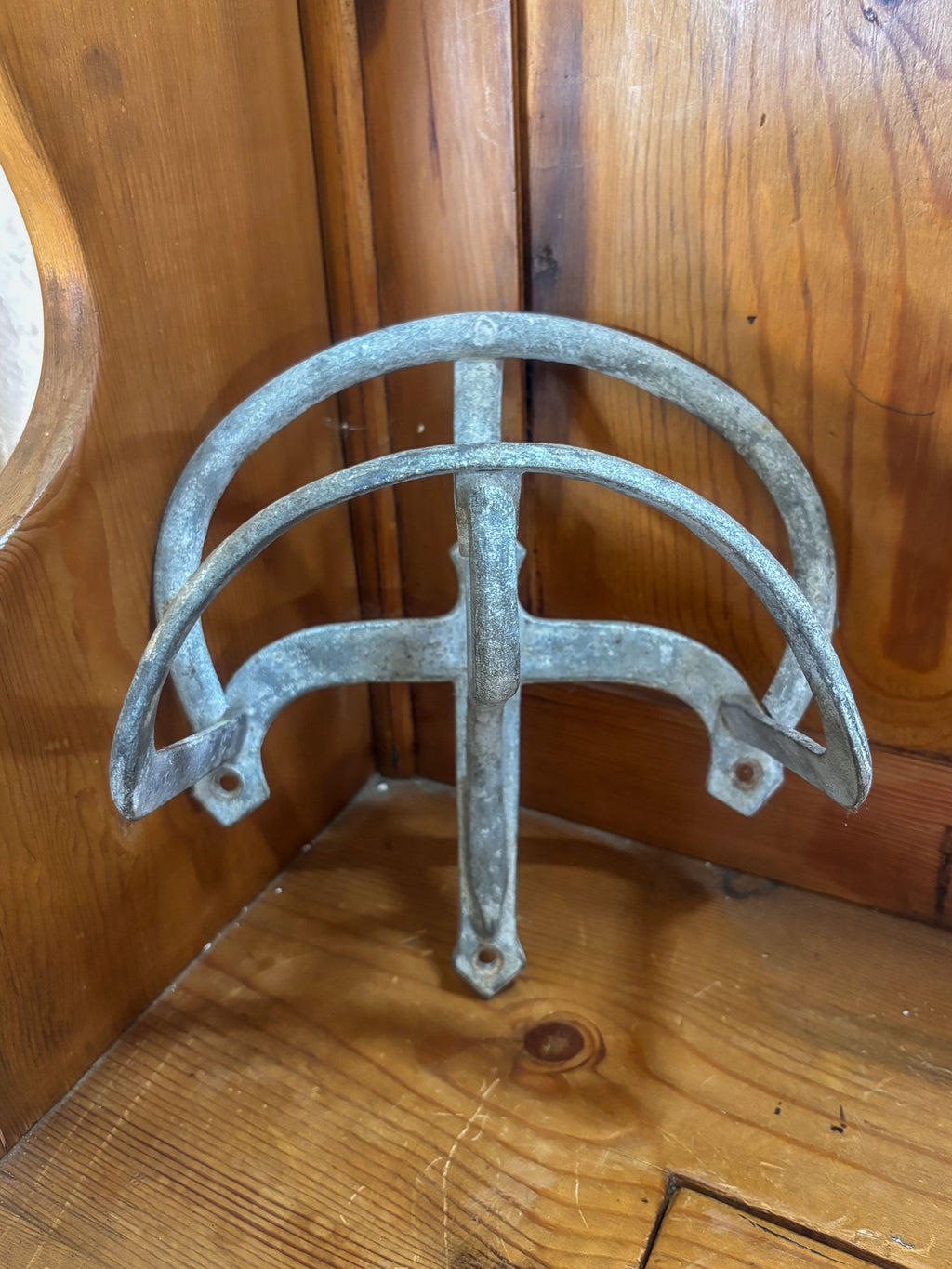 Metal wall bracket on a wooden surface