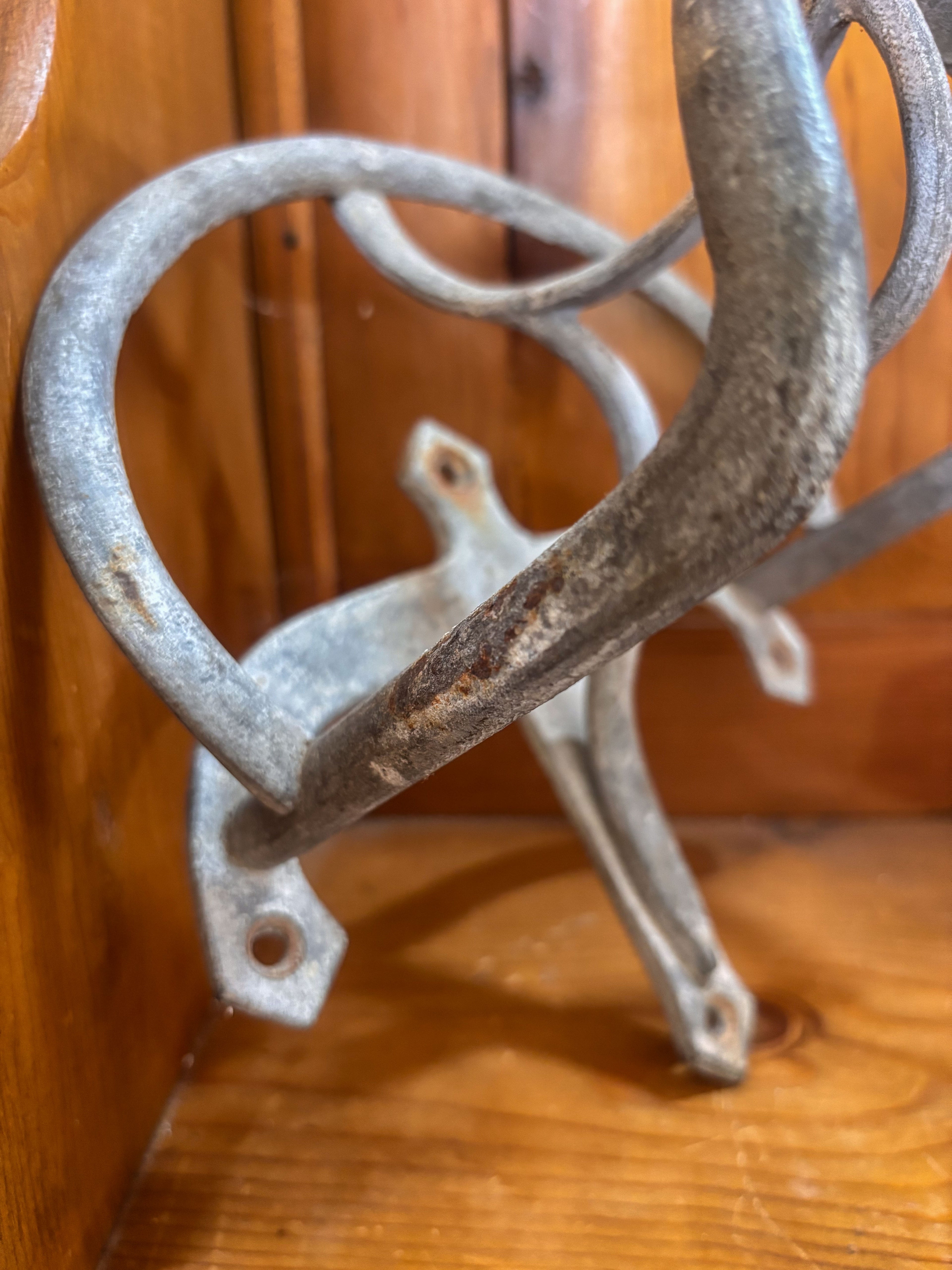 Rustic metal bracket on a wooden surface