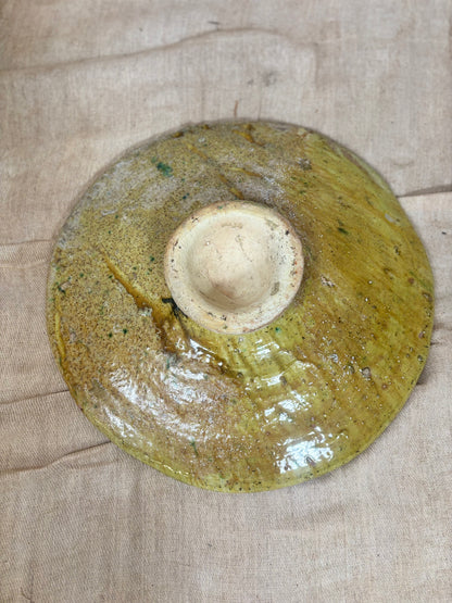Ceramic plate with a textured surface on a beige fabric background