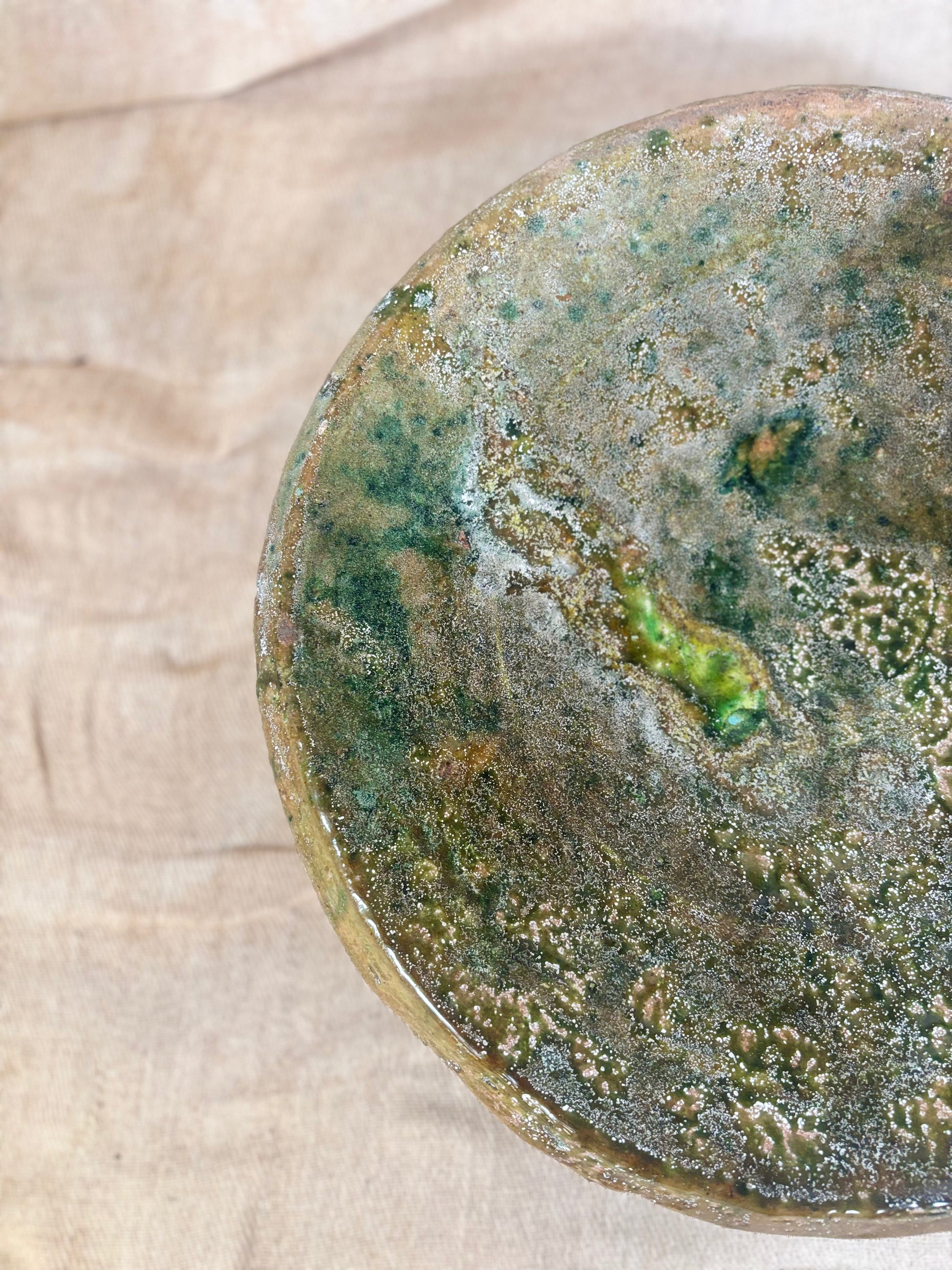 Close-up of a textured ceramic plate on a wooden surface