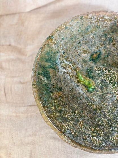 Close-up of a textured ceramic plate on a wooden surface