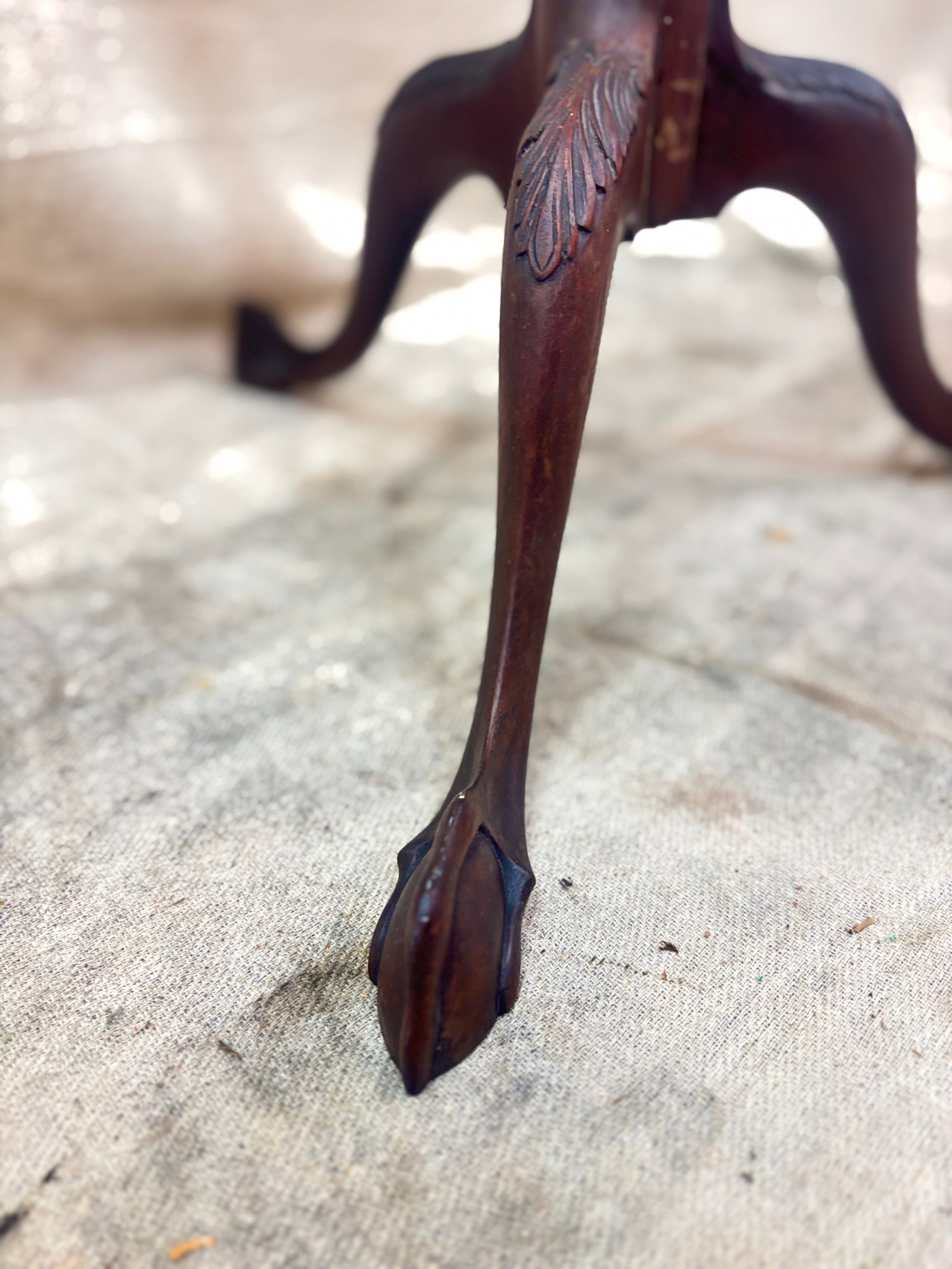 Close-up of a decorative wooden leg on a textured surface