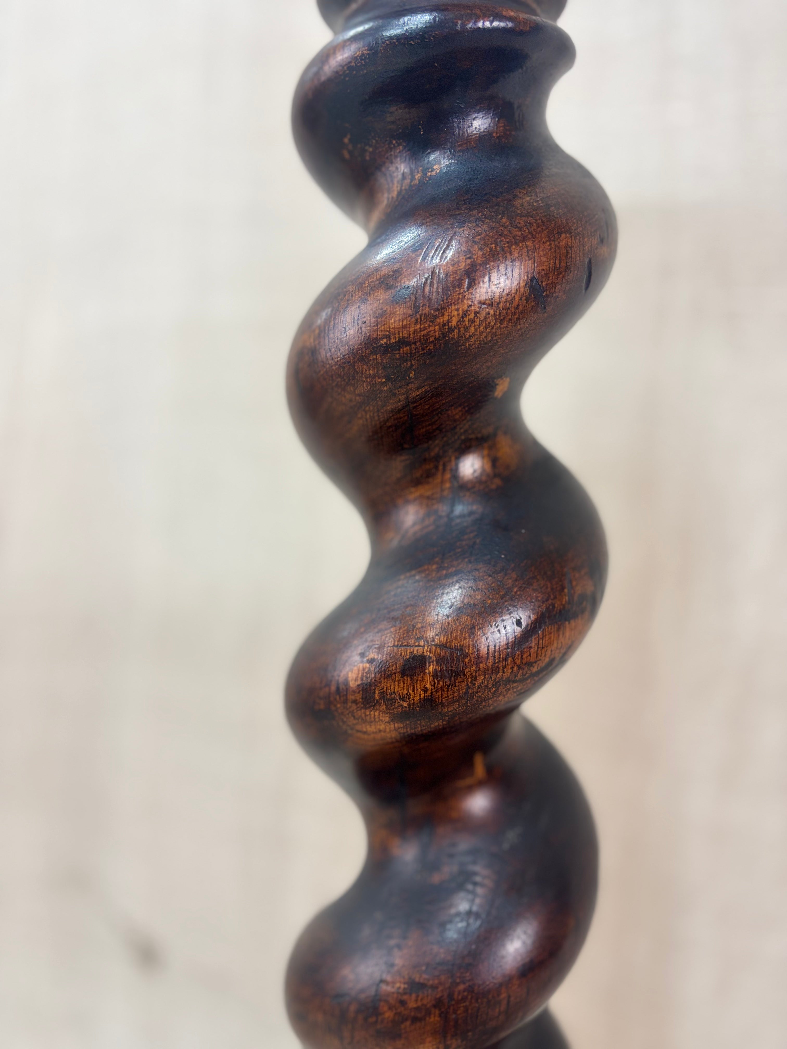 Close-up of a wooden spindle with a textured surface on a light background
