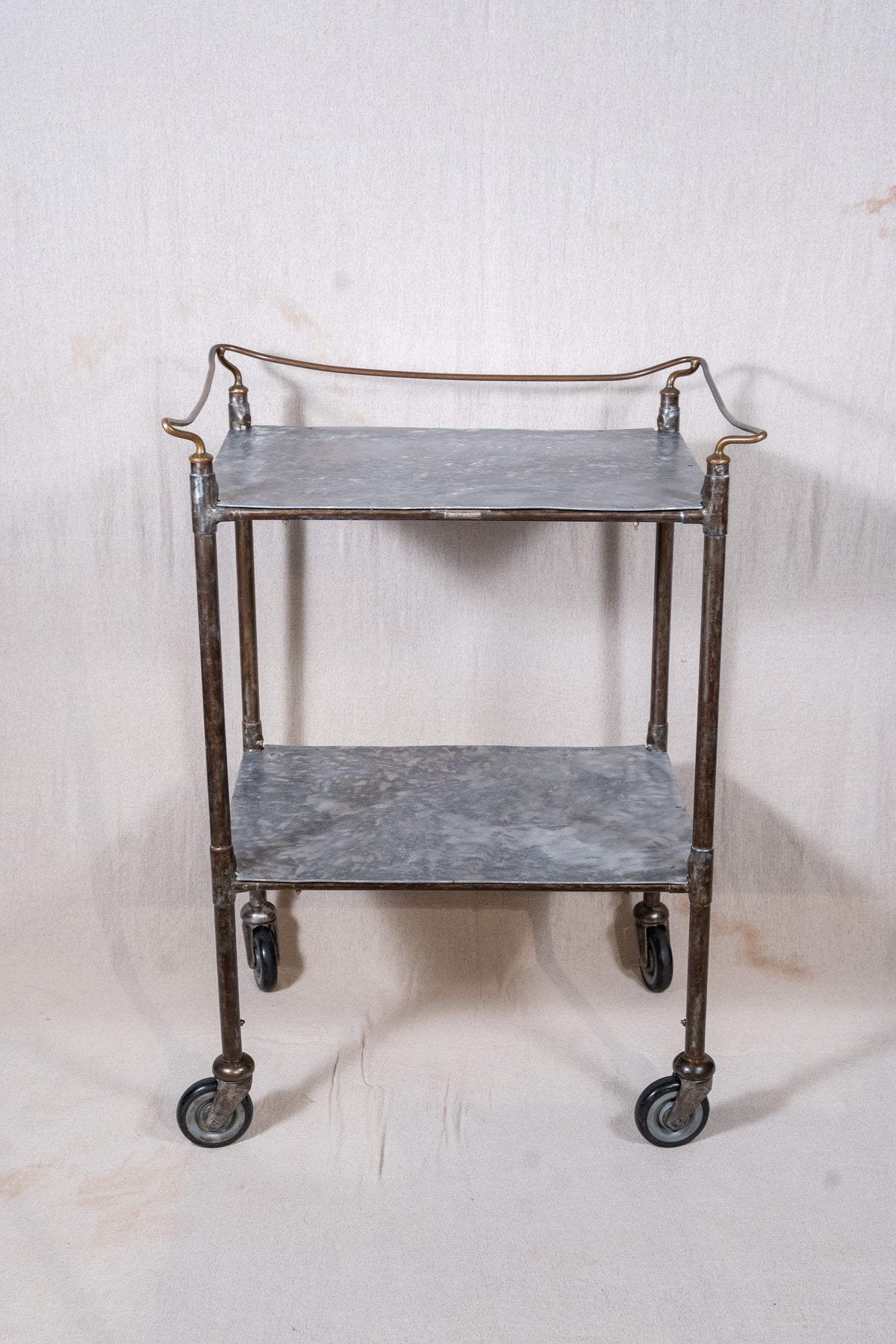 Vintage British medical trolley dating from the 1920s to 1940s, with tiered galvanised metal shelves, tubular steel frame and original swivel castors.