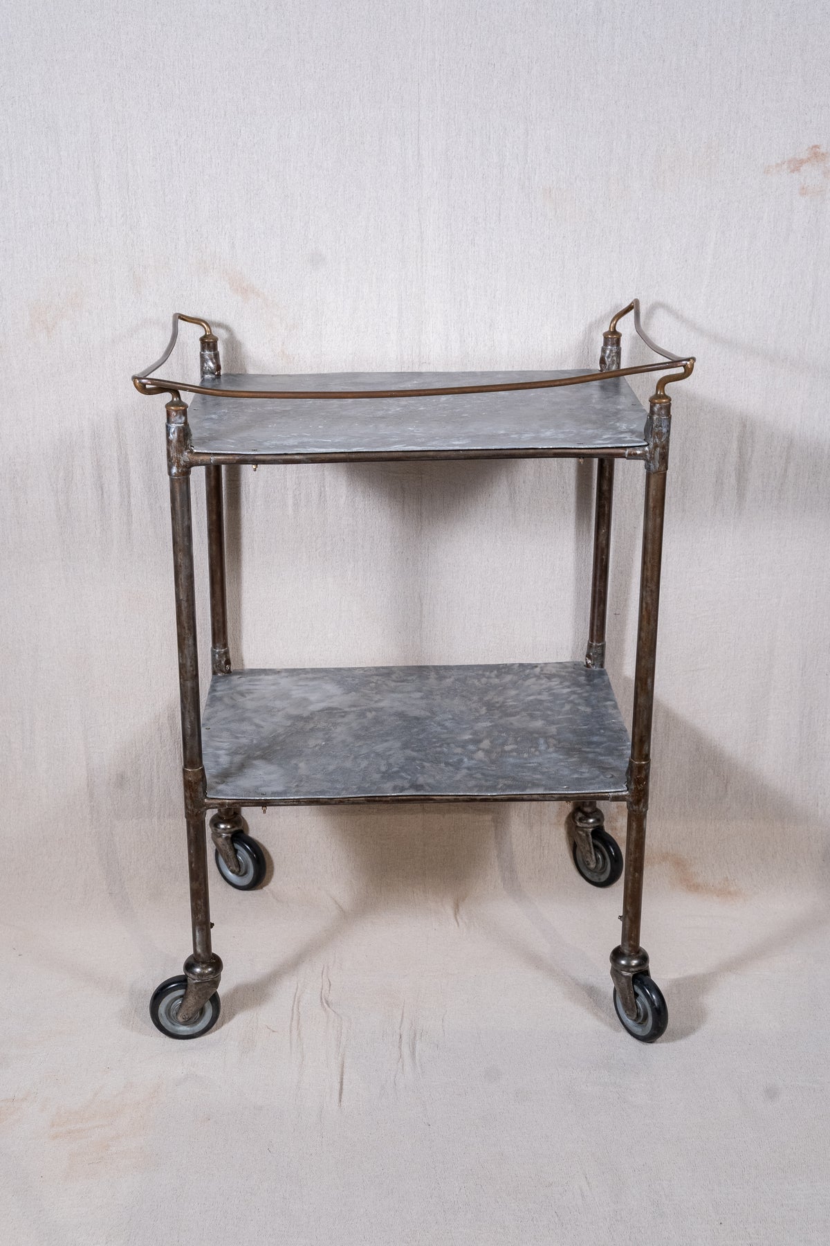Vintage British medical trolley dating from the 1920s to 1940s, with tiered galvanised metal shelves, tubular steel frame and original swivel castors.