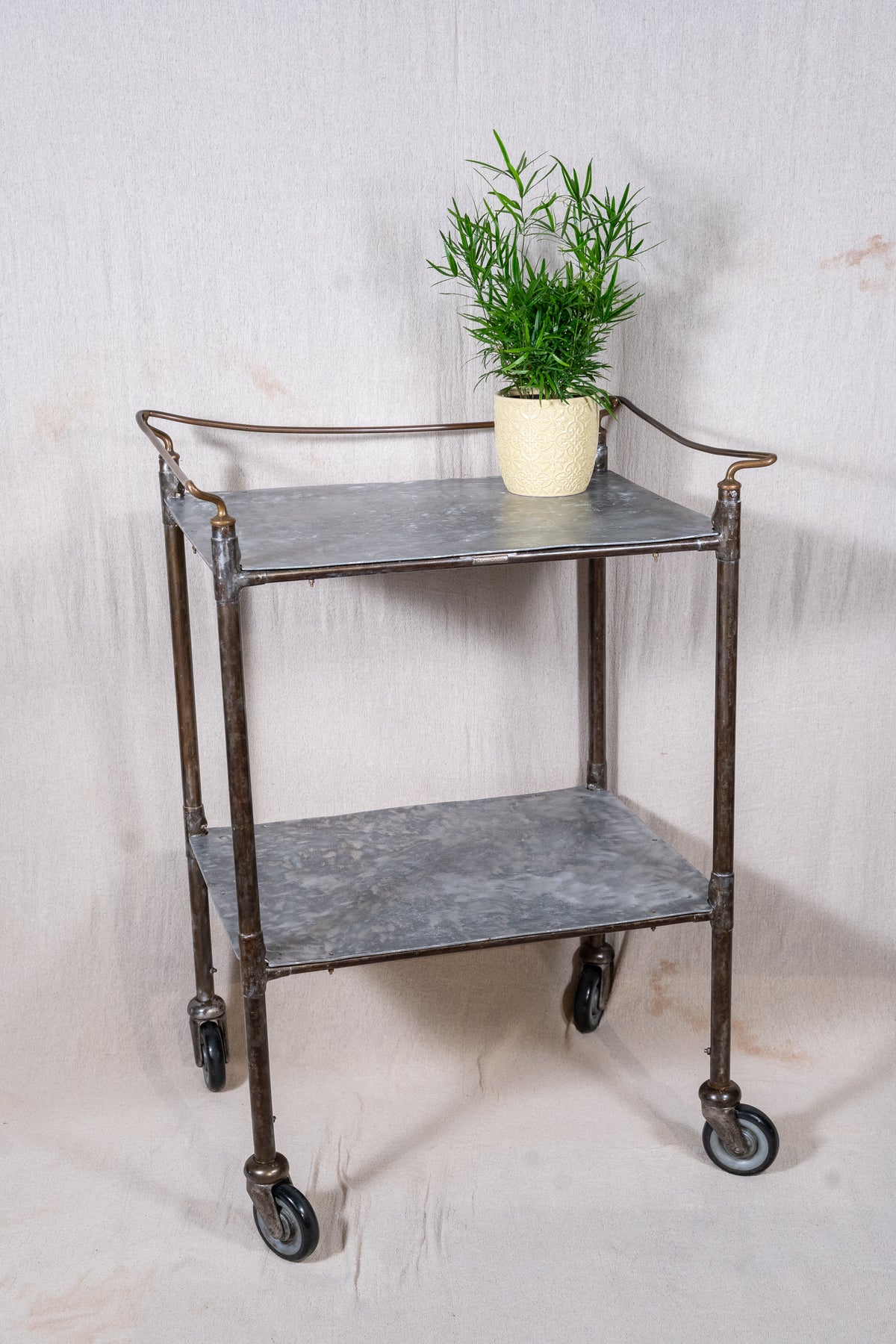 Vintage British medical trolley dating from the 1920s to 1940s, with tiered galvanised metal shelves, tubular steel frame and original swivel castors.