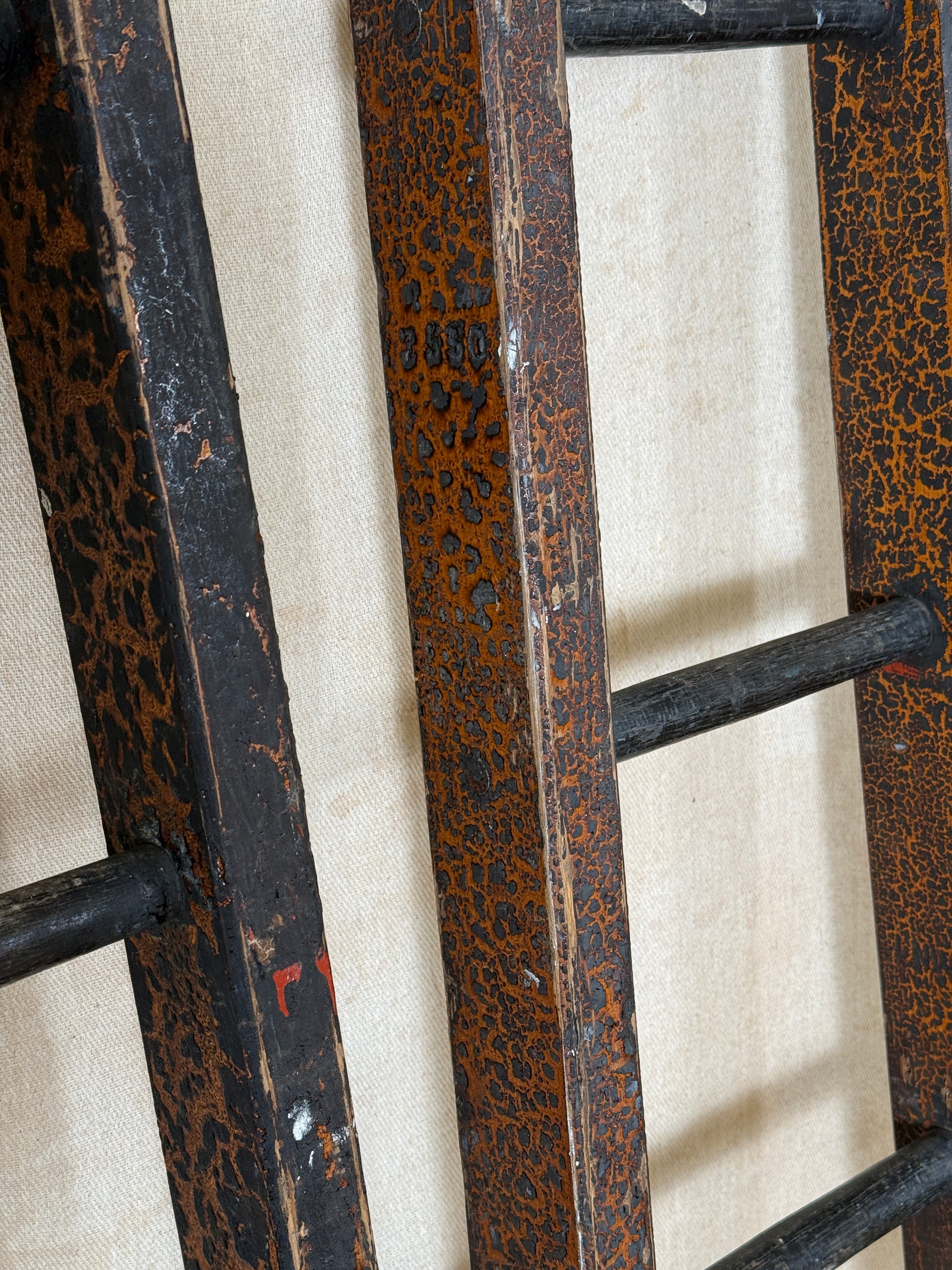 Pair of vintage wooden ladders with worn black paint