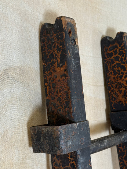 Pair of vintage wooden ladders with worn black paint