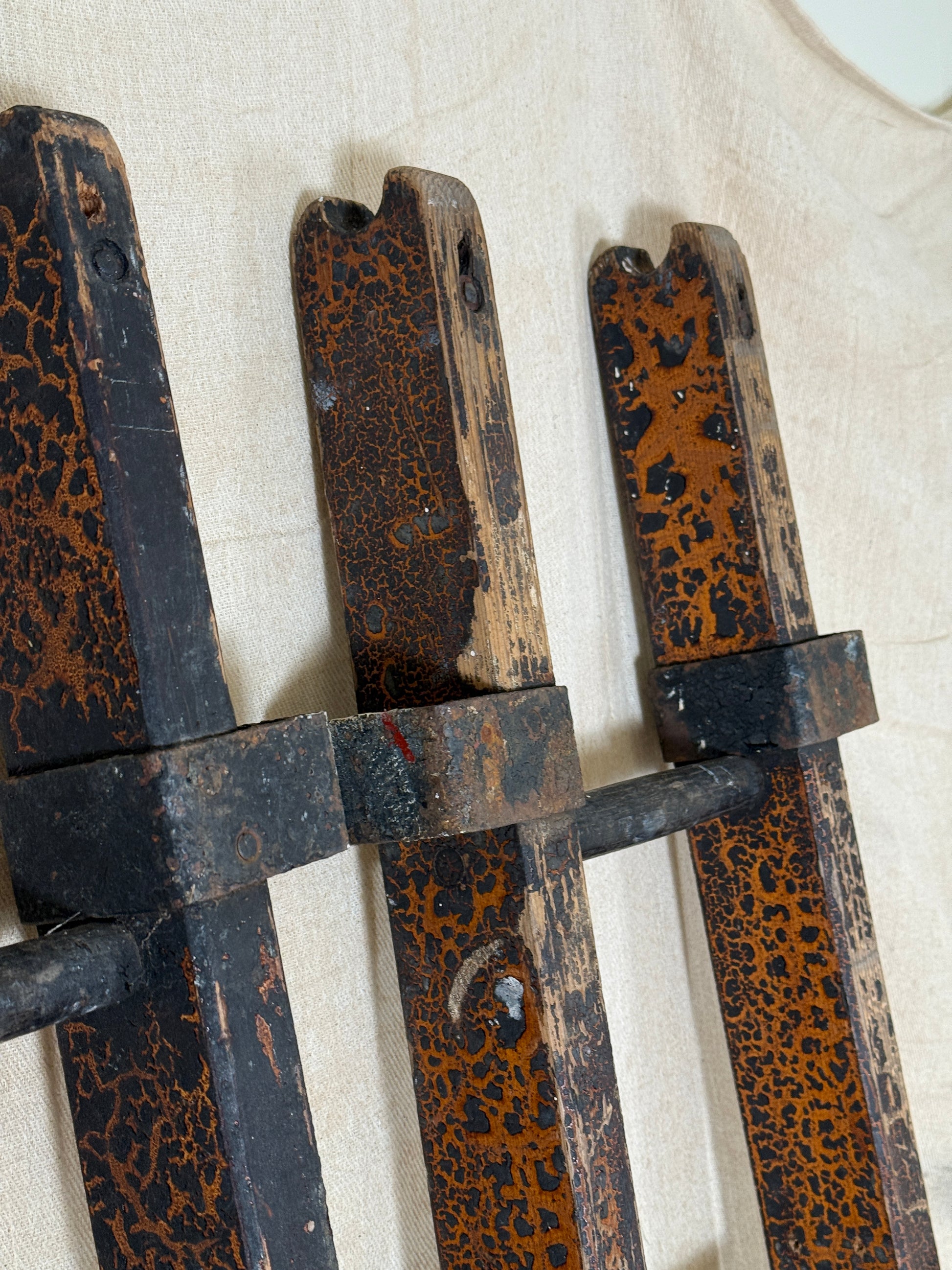 Pair of vintage wooden ladders with worn black paint