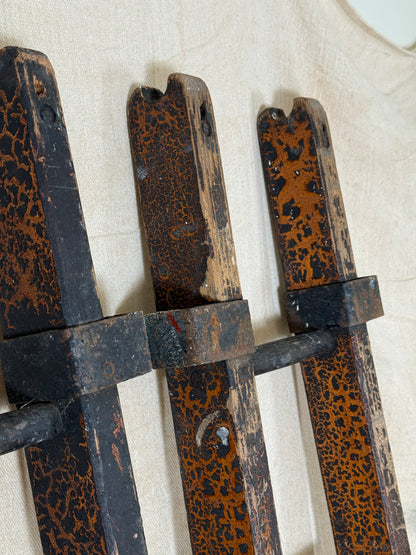 Pair of vintage wooden ladders with worn black paint