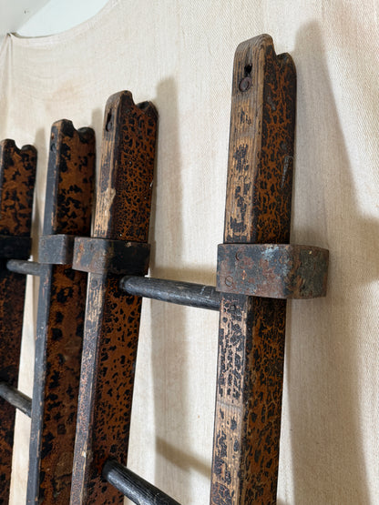 Pair of vintage wooden ladders with worn black paint