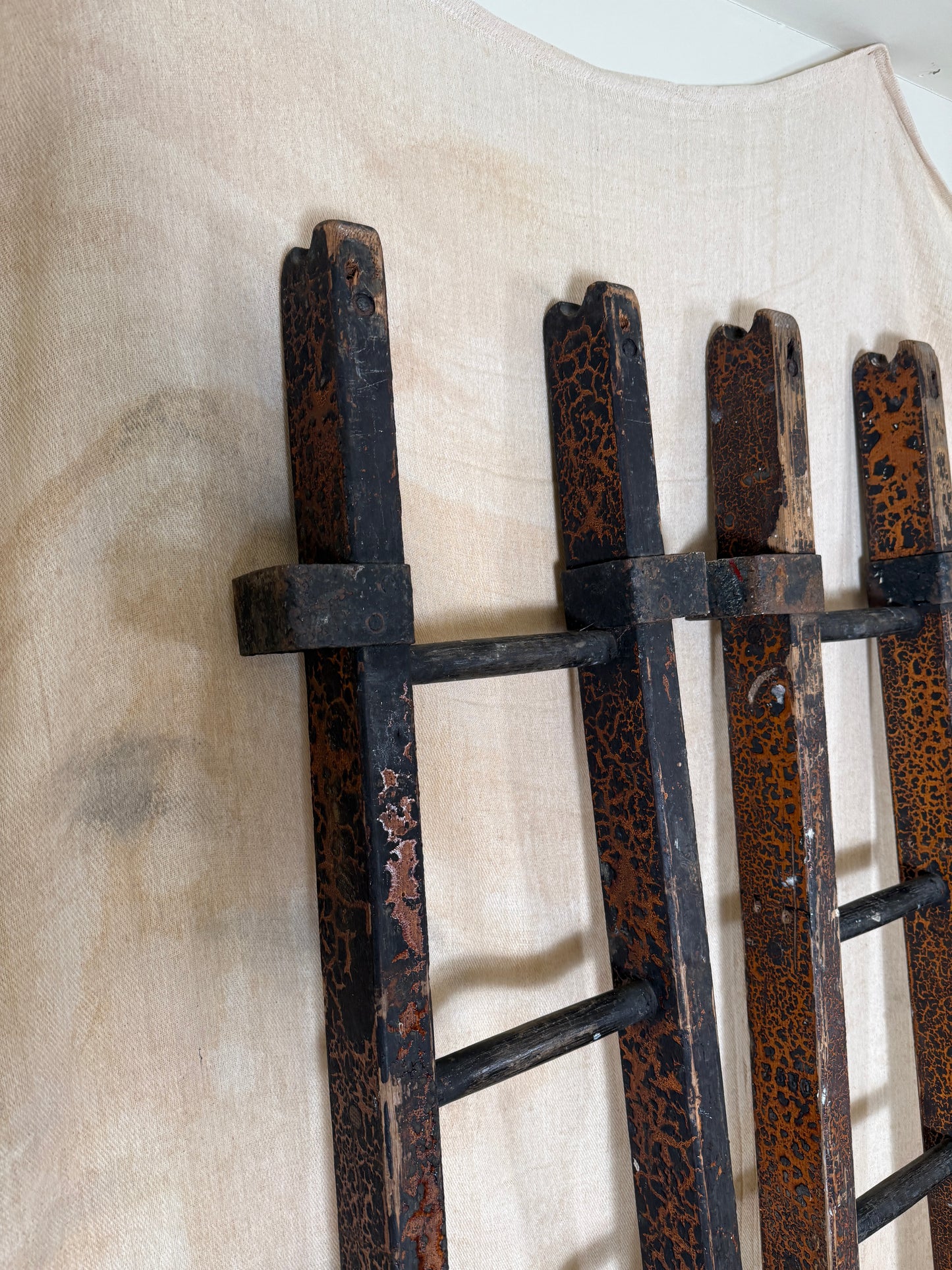 Pair of vintage wooden ladders with worn black paint