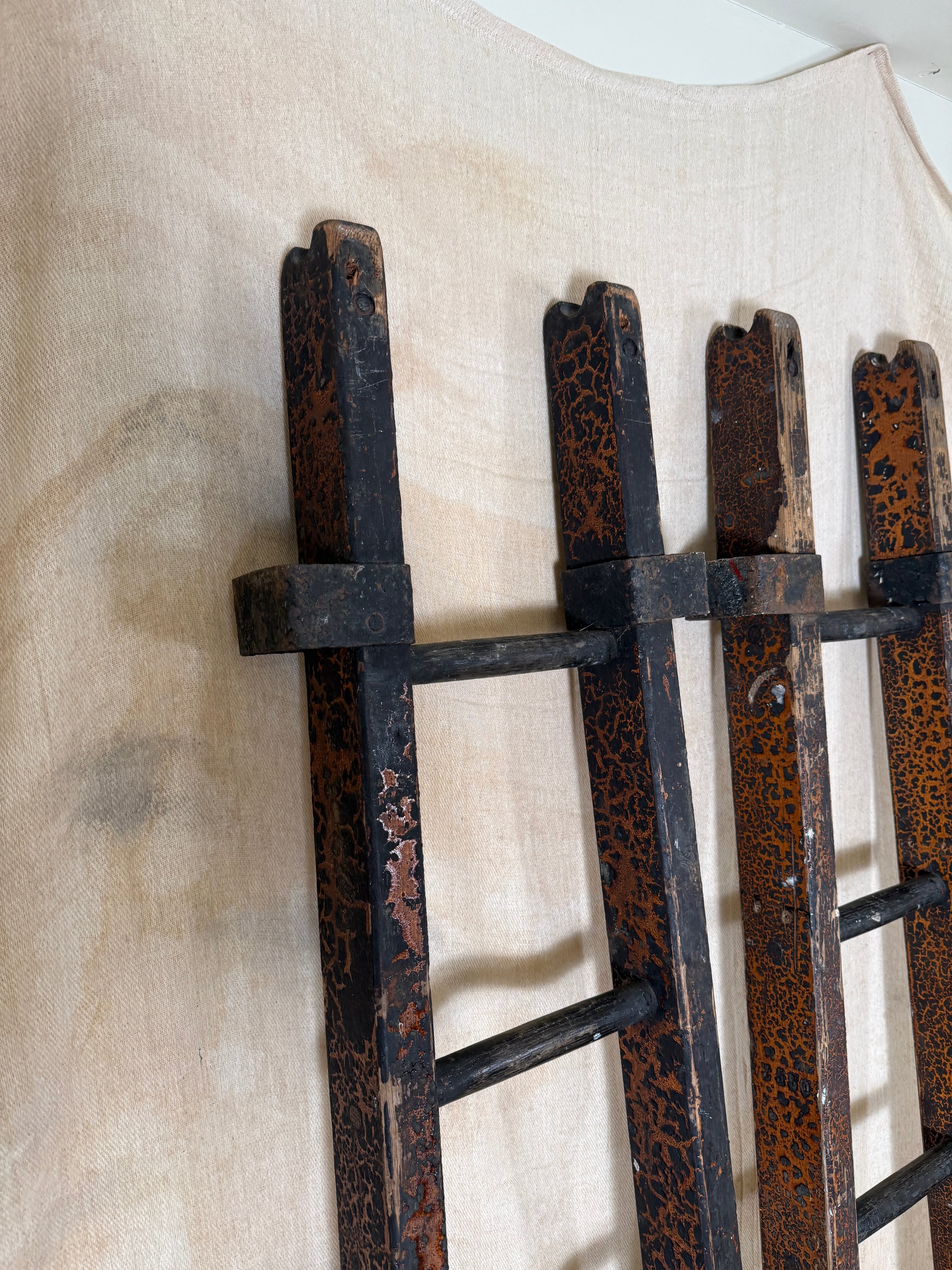Pair of vintage wooden ladders with worn black paint