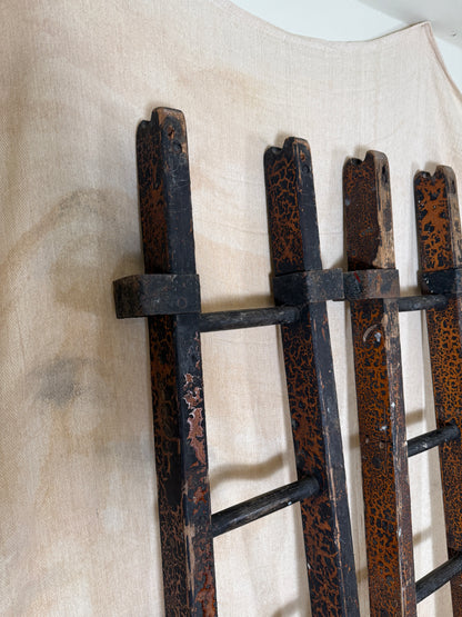 Pair of vintage wooden ladders with worn black paint