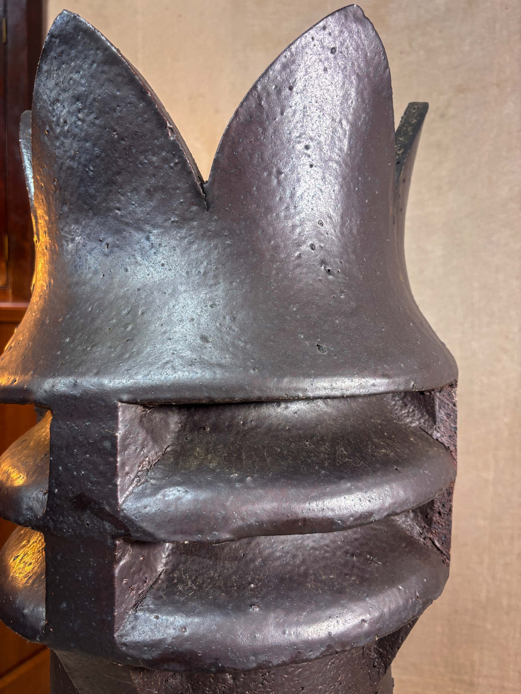Close-up of a crown top chimney on a beige background
