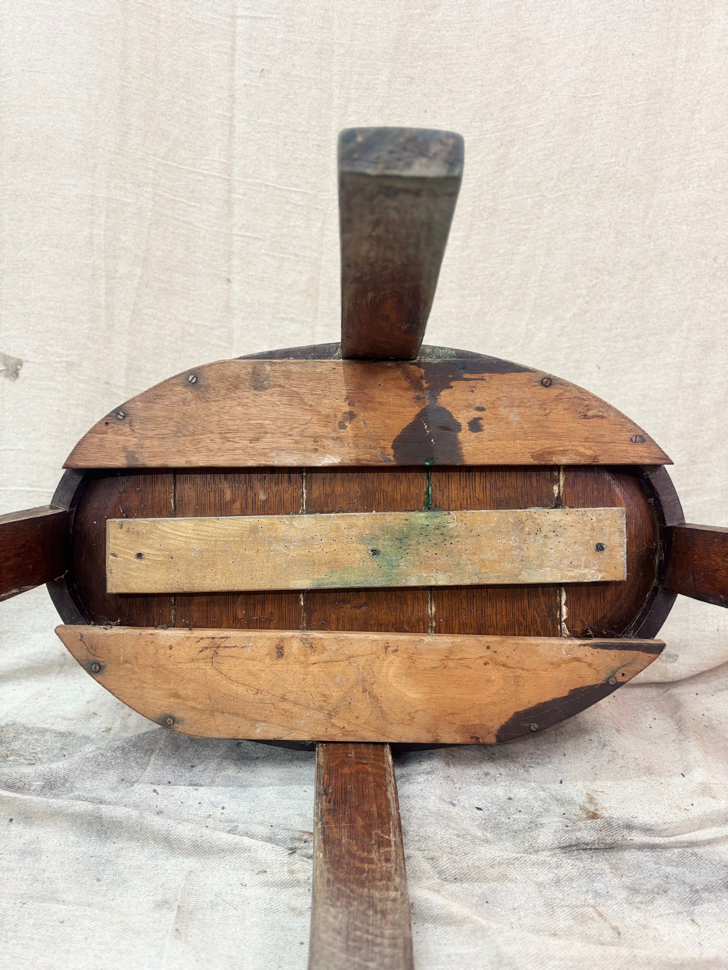 Wooden paddle with a handle on a textured beige background
