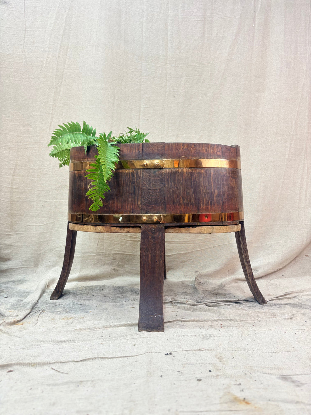 Wooden planter with legs on a textured surface
