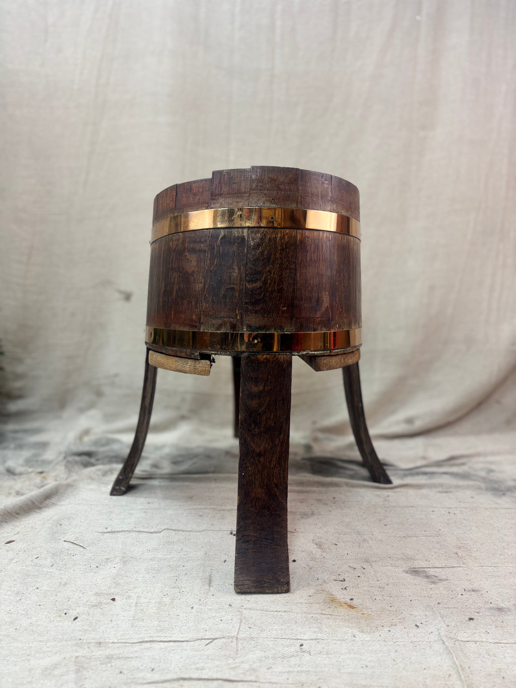 Wooden barrel with metal bands on a textured surface