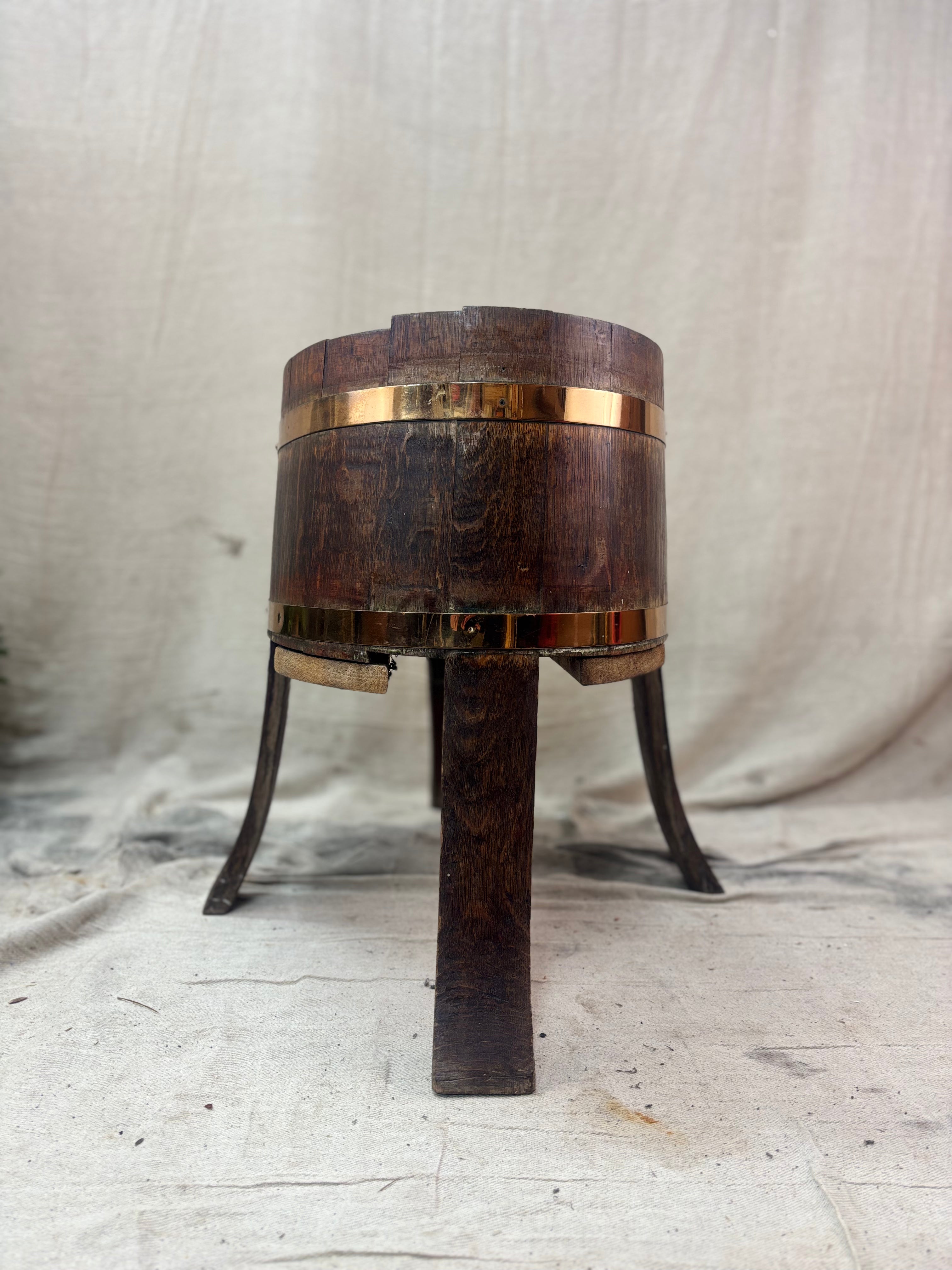 Wooden barrel with metal bands on a textured surface