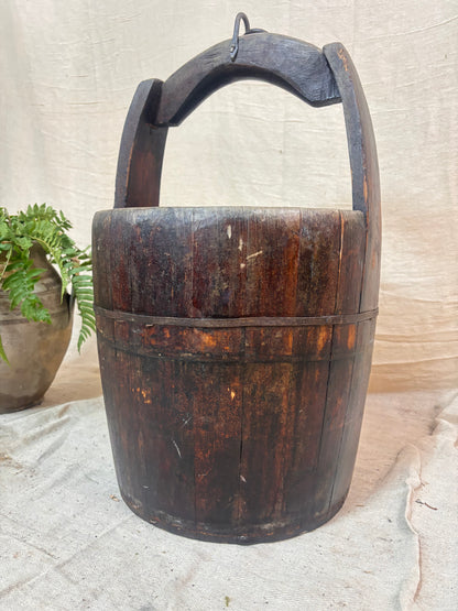 Vintage wooden well bucket with metal bands