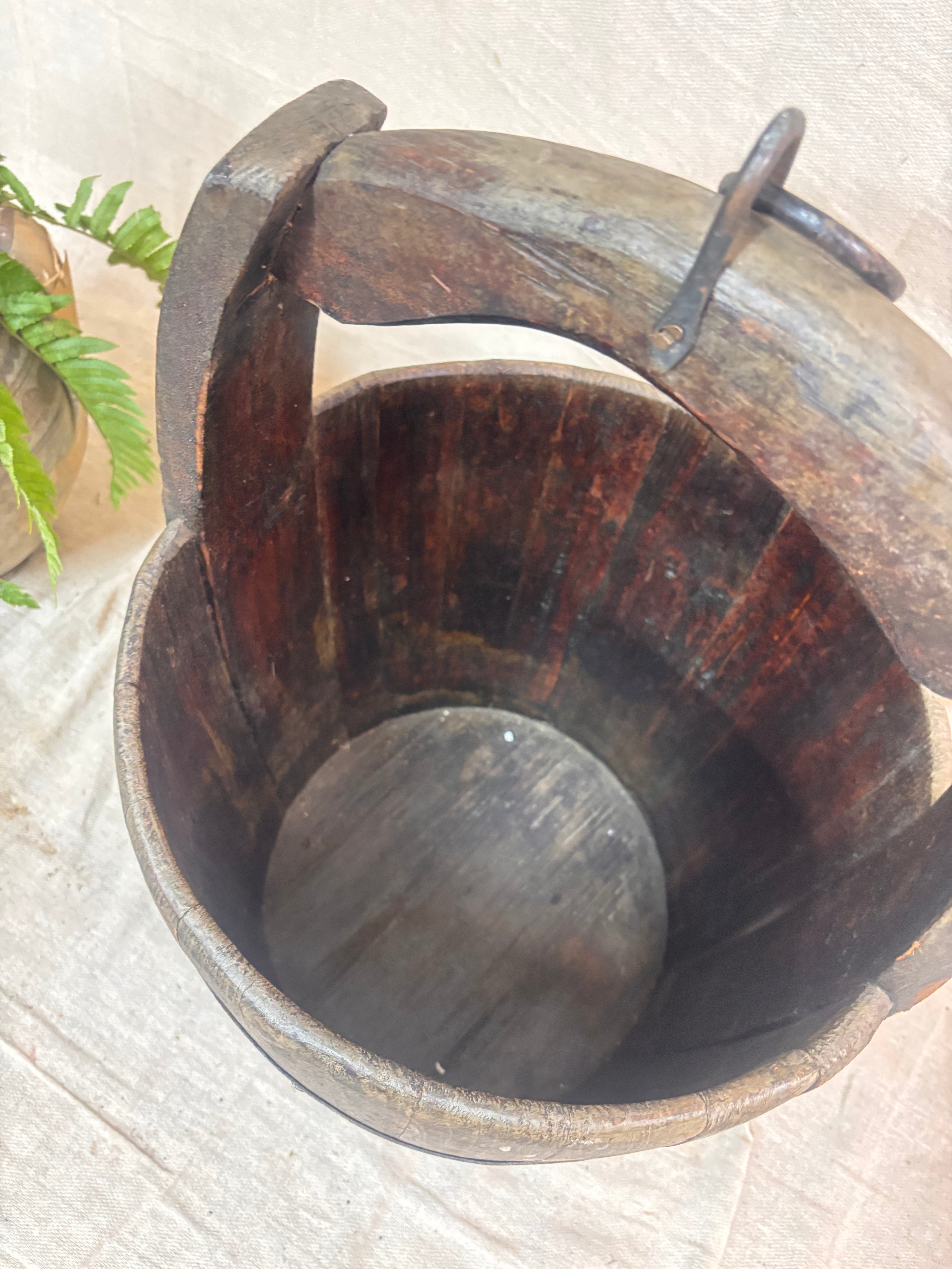 Vintage wooden well bucket with metal bands