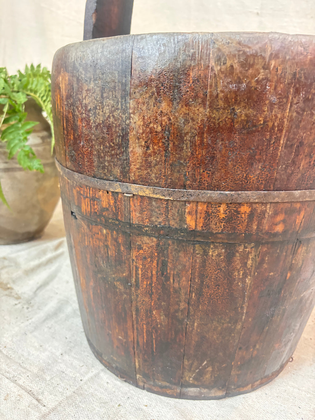 Vintage wooden well bucket with metal bands