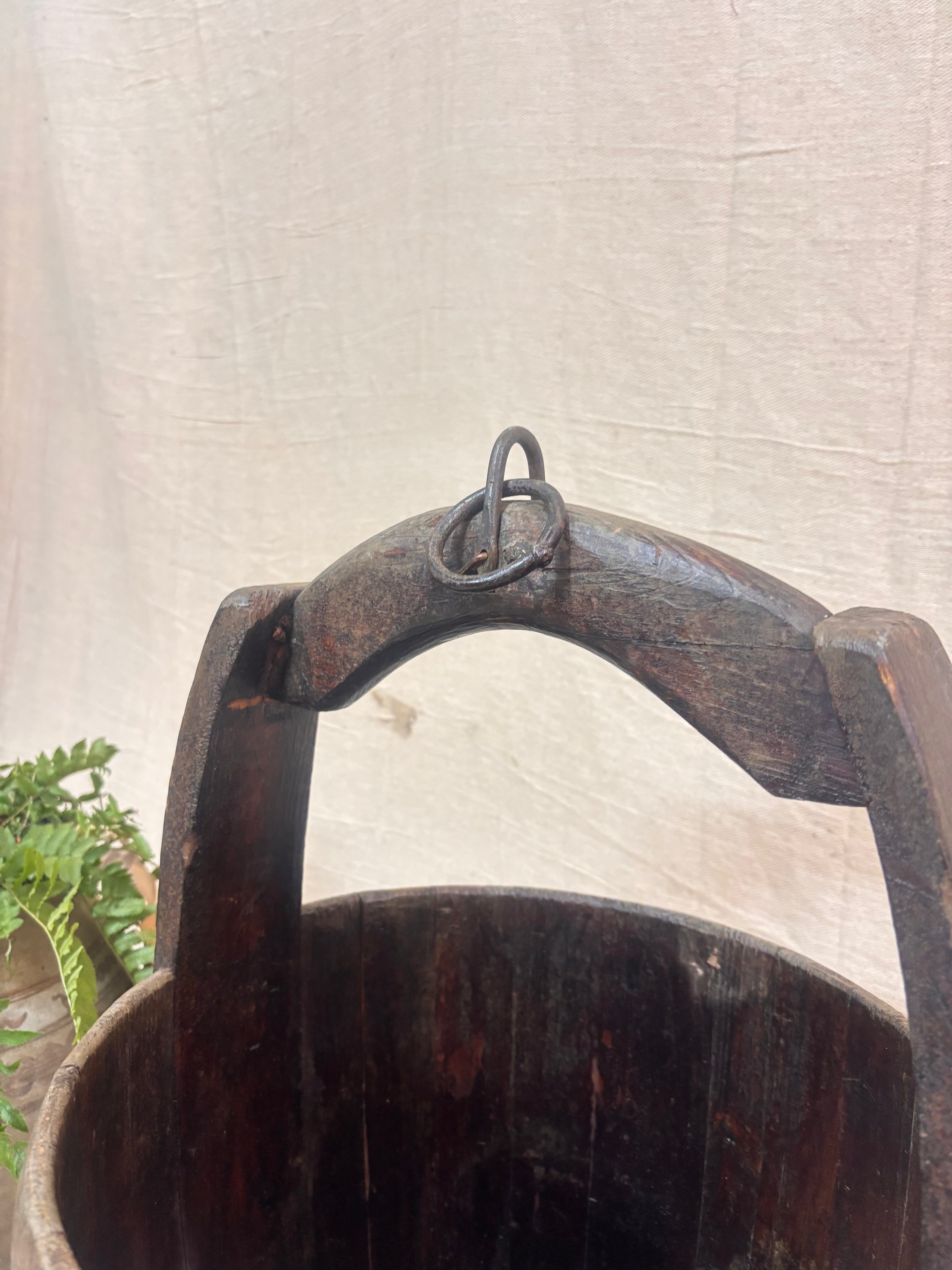 Vintage wooden well bucket with metal bands