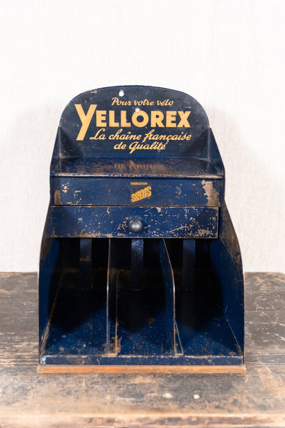 Vintage French metal chain display cabinet by Sedis, with original Yellorex bicycle and Yellow motorcycle chain advertising, storage slots and central drawer.