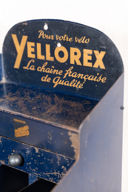 Vintage French metal chain display cabinet by Sedis, with original Yellorex bicycle and Yellow motorcycle chain advertising, storage slots and central drawer.