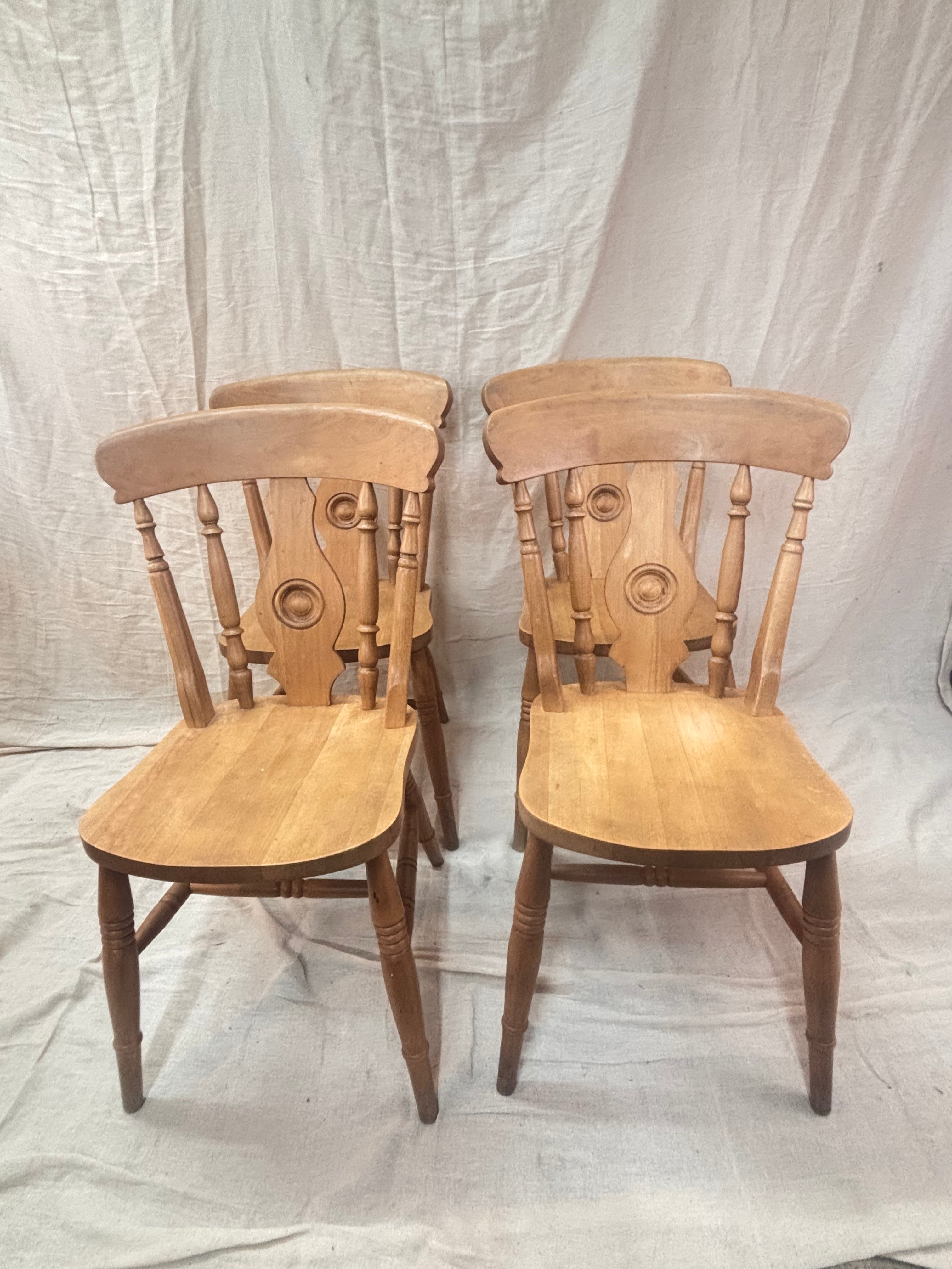4 wooden chairs on a cloth background