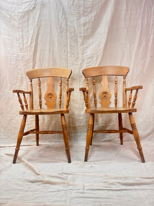 two wooden chairs on a neutral cloth background