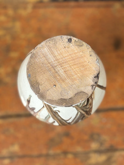 Close-up of ceramic vase base  on a wooden surface