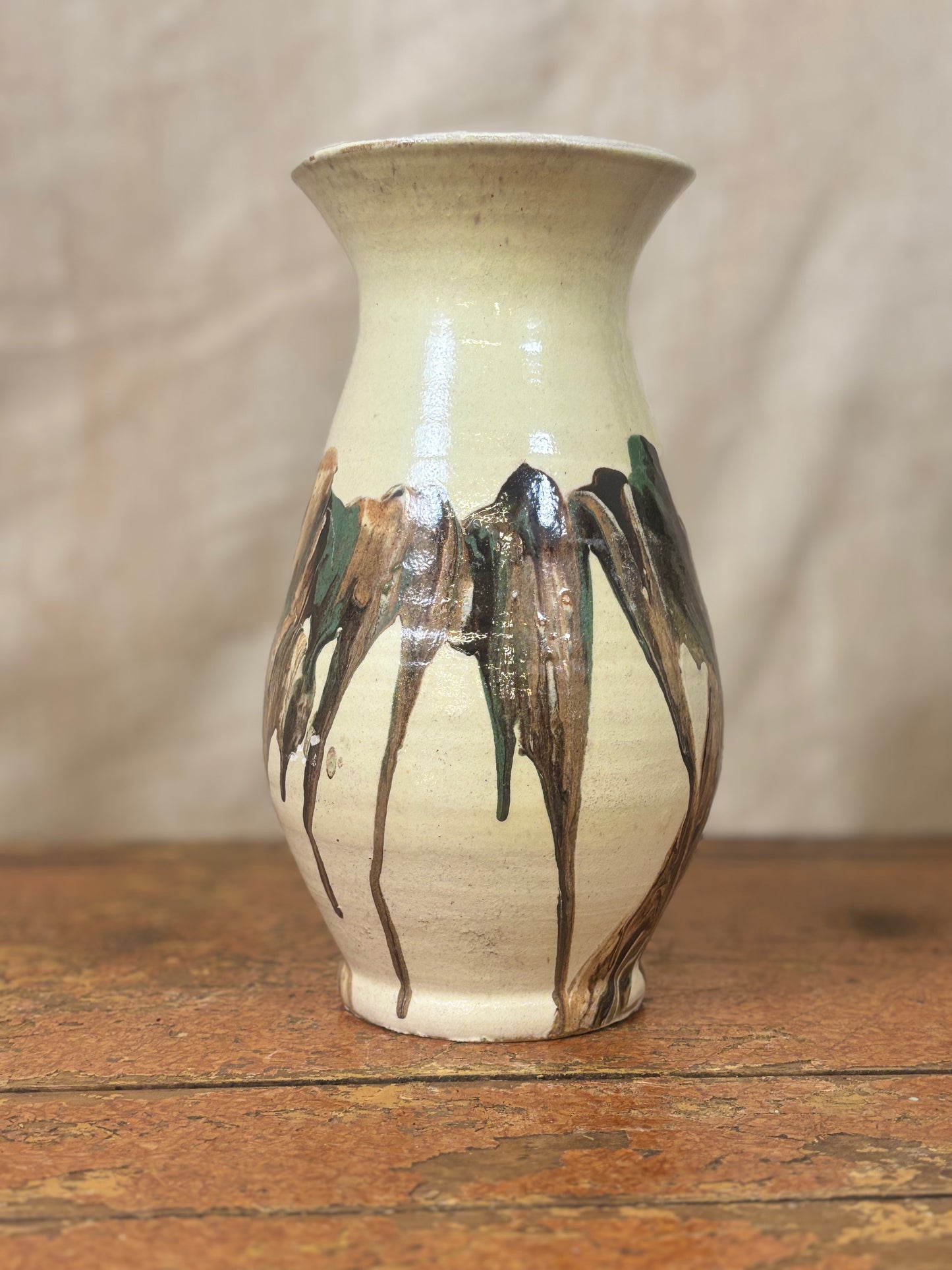 Ceramic vase with artistic design on a wooden surface