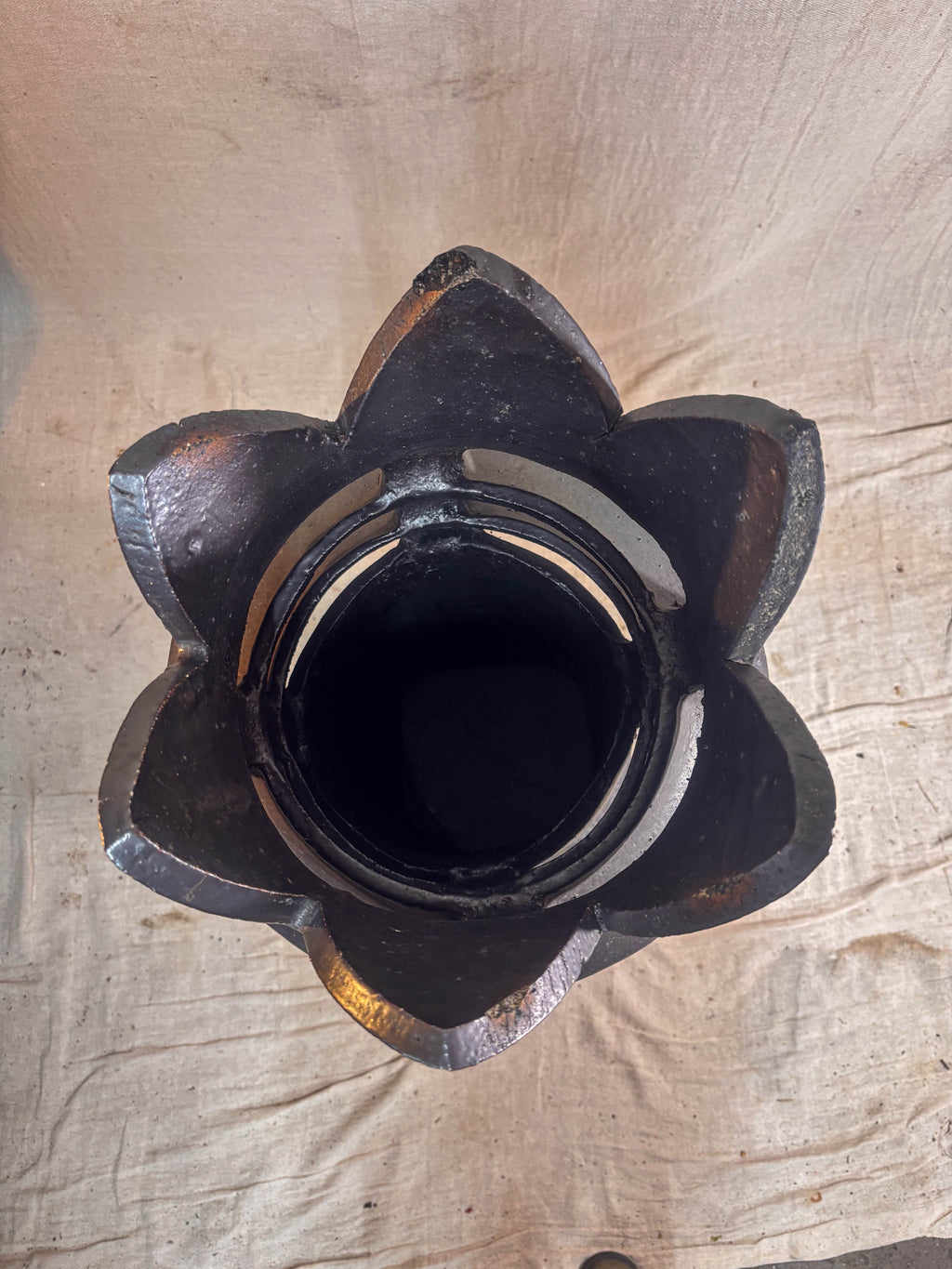 Interior image of a chimney pot from above on a beige background